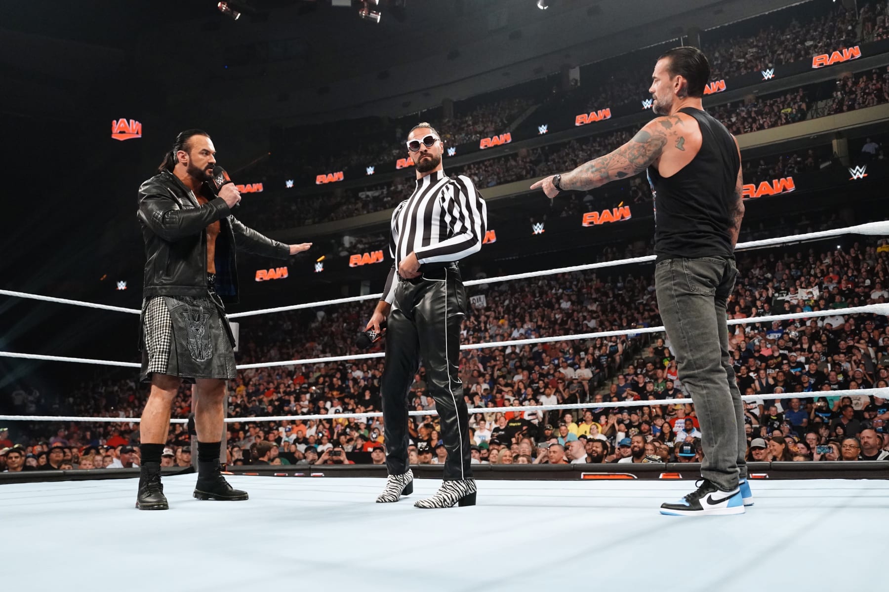 ST PAUL, MINNESOTA - JULY 29: (L-R) Drew Mcintyre, Seth Rollins and CM Punk confront each other in the ring during WWE's Monday Night RAW at Xcel Energy Center on July 29, 2024 in St Paul, Minnesota.  (Photo by WWE/Getty Images)