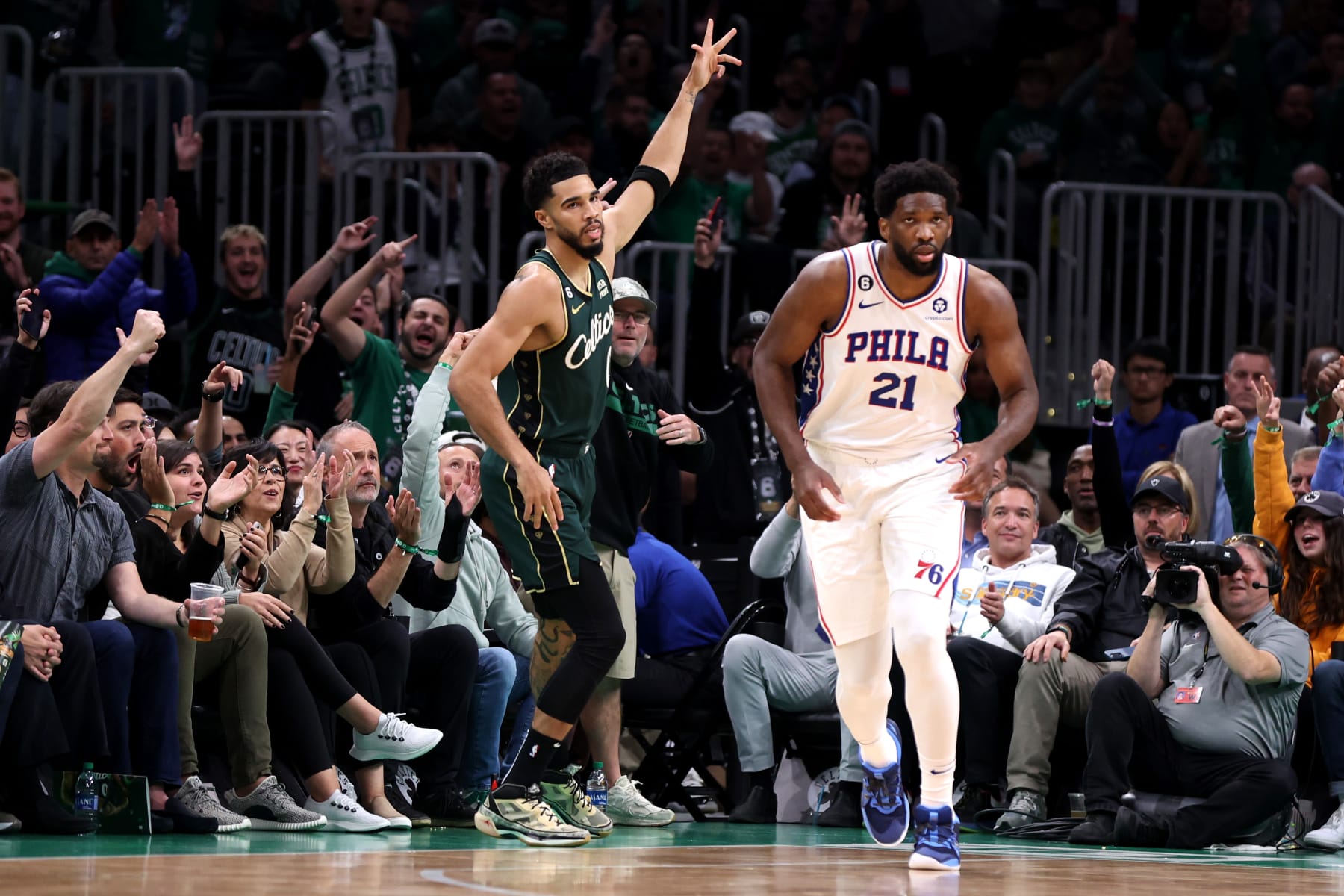 BOSTON, MASSACHUSETTS - OCTOBER 18: Jayson Tatum #0 of the Boston Celtics celebrates hitting a three-point shot in front of Joel Embiid #21 of the Philadelphia 76ers during the first half at TD Garden on October 18, 2022 in Boston, Massachusetts. NOTE TO USER: User expressly acknowledges and agrees that, by downloading and or using this photograph, User is consenting to the terms and conditions of the Getty Images License Agreement. (Photo by Maddie Meyer/Getty Images)