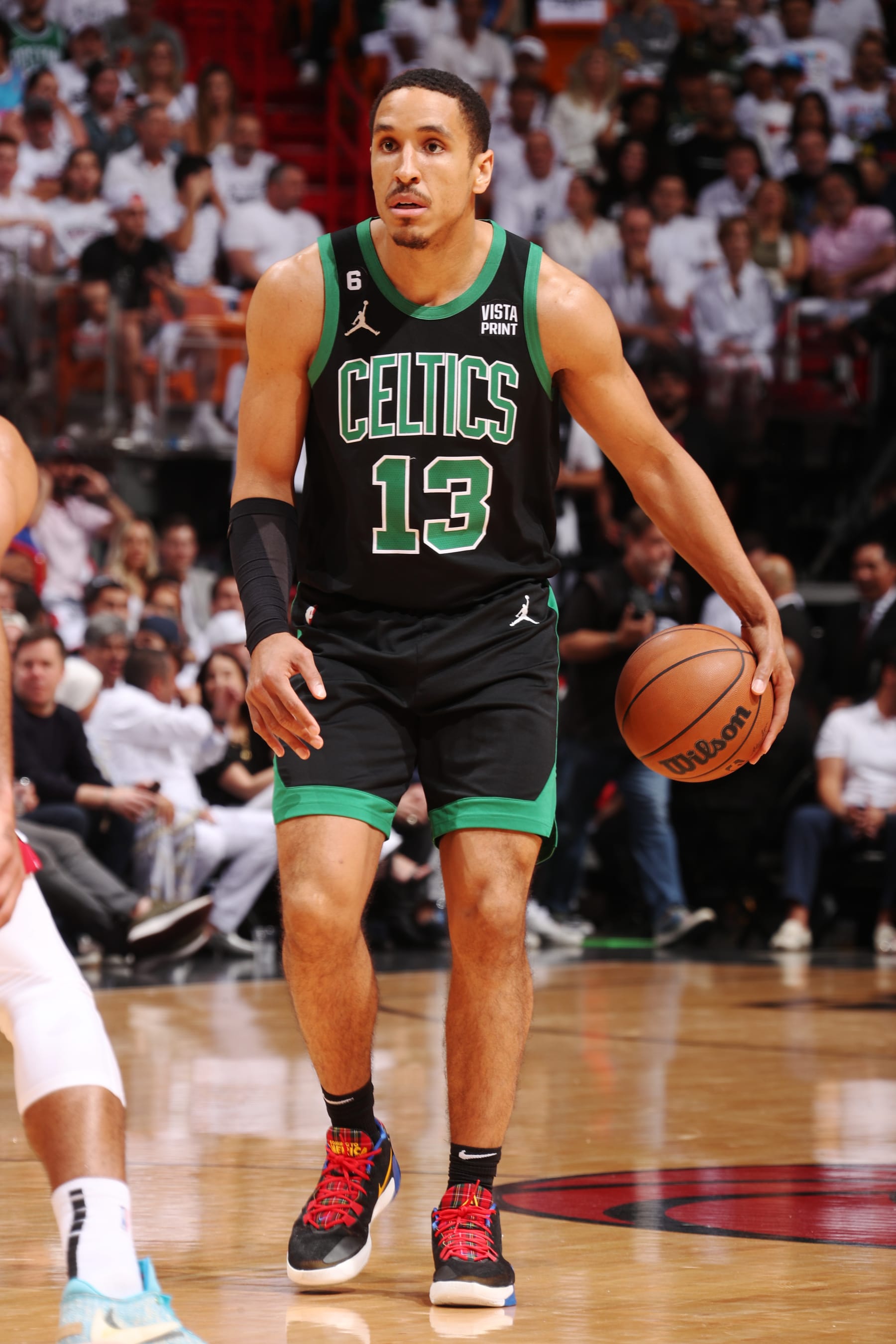 MIAMI, FL - MAY 21: Malcolm Brogdon #13 of the Boston Celtics dribbles the ball during Round 3 Game 3 of the Eastern Conference Finals 2023 NBA Playoffs against the Miami Heat on May 21, 2023 at the Kaseya Center in Miami, Florida. NOTE TO USER: User expressly acknowledges and agrees that, by downloading and or using this Photograph, user is consenting to the terms and conditions of the Getty Images License Agreement. Mandatory Copyright Notice: Copyright 2023 NBAE (Photo by Issac Baldizon/NBAE via Getty Images)