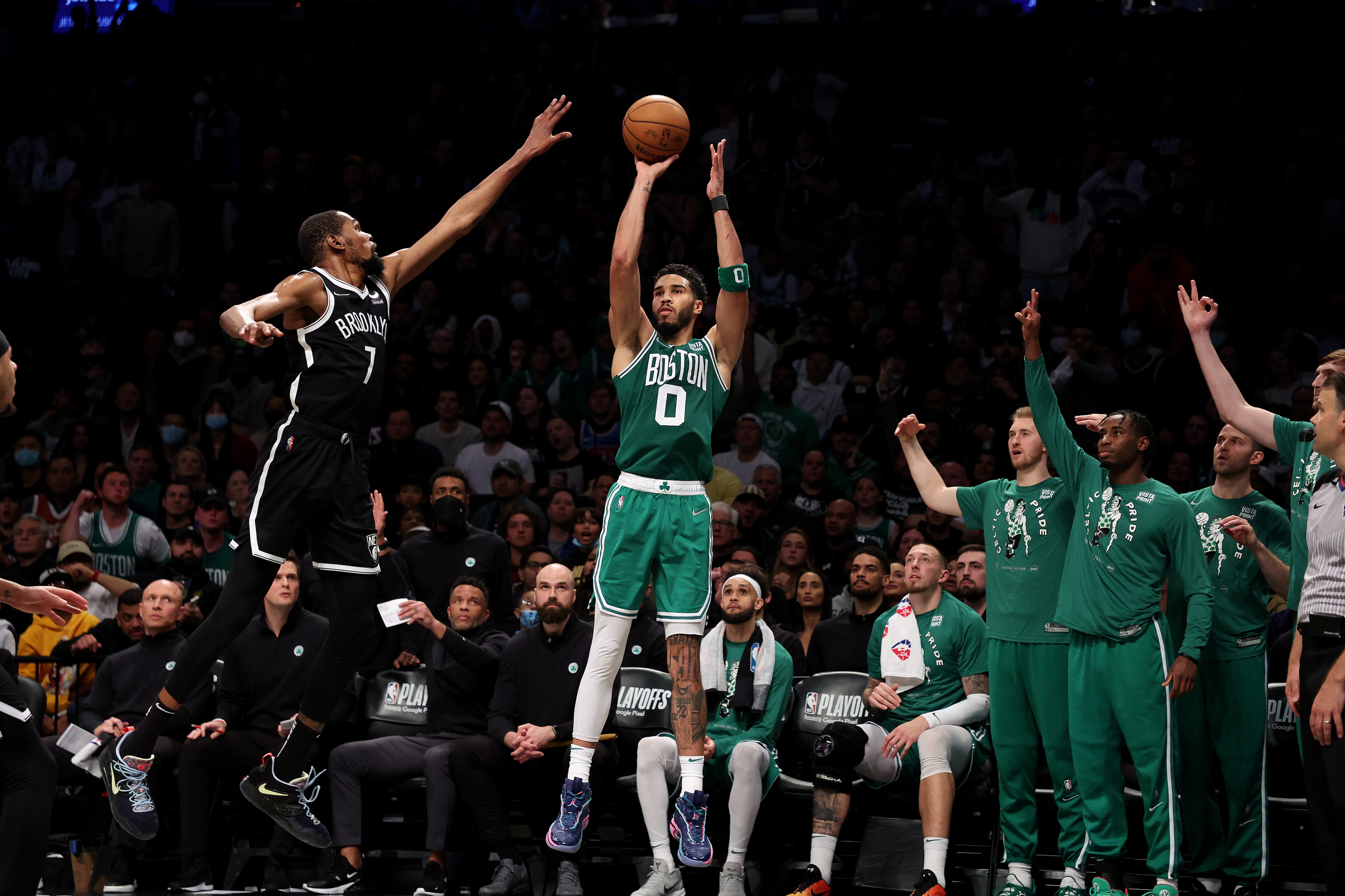 NEW YORK, NEW YORK - APRIL 23:  Jayson Tatum #0 of the Boston Celtics hits a three pointer against Kevin Durant #7 of the Brooklyn Nets during Game Three of the Eastern Conference First Round NBA Playoffs at Barclays Center on April 23, 2022 in New York City.  NOTE TO USER: User expressly acknowledges and agrees that, by downloading and or using this photograph, User is consenting to the terms and conditions of the Getty Images License Agreement.  (Photo by Al Bello/Getty Images).