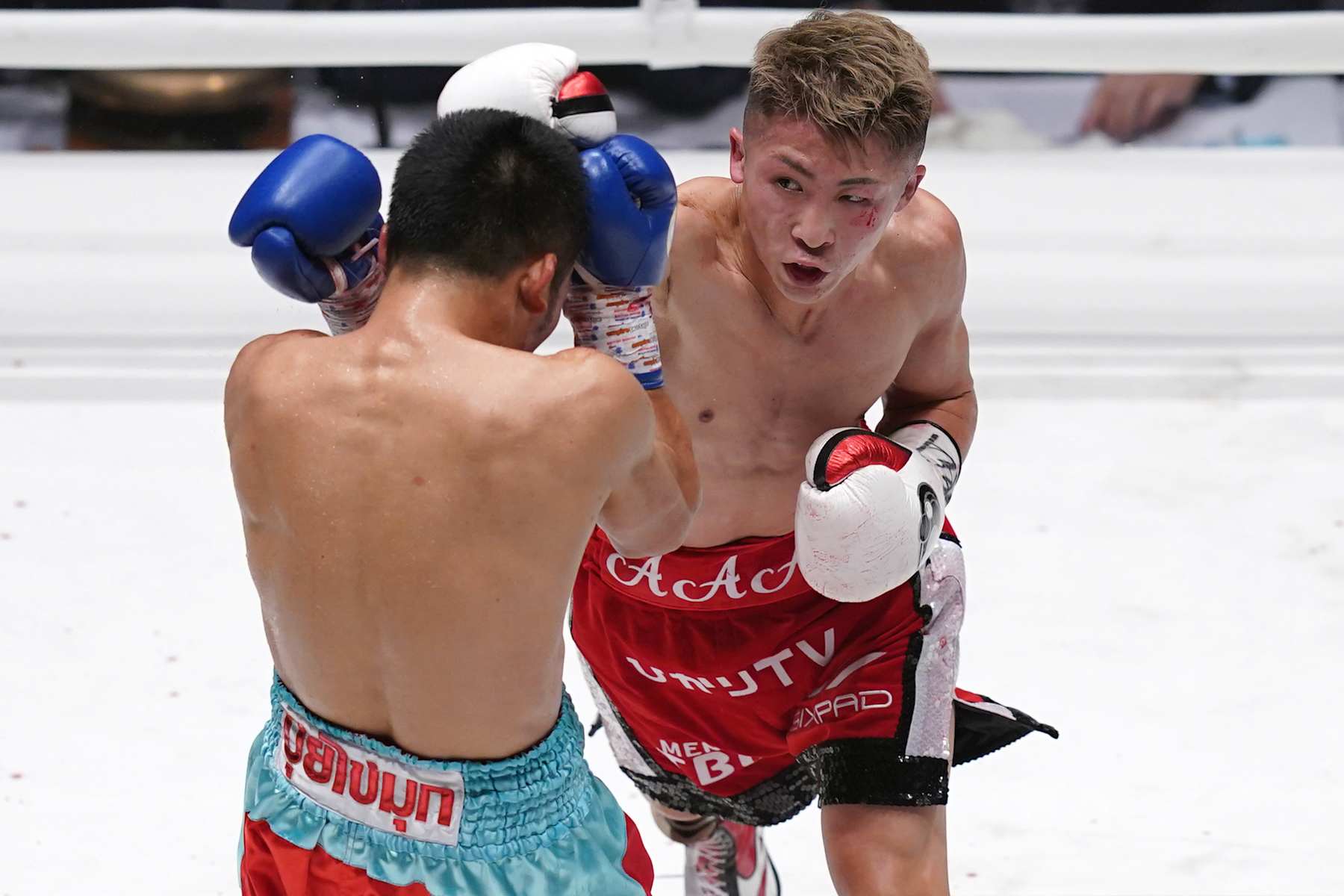TOKYO, JAPAN - DECEMBER 14: Naoya Inoue (R) of Japan punches Aran Dipaen of Thailand during the WBA Super Bantamweight and IBO Bantamweight title bout at Ryogoku Kokugikan on December 14, 2021 in Tokyo, Japan. (Photo by Toru Hanai/Getty Images)