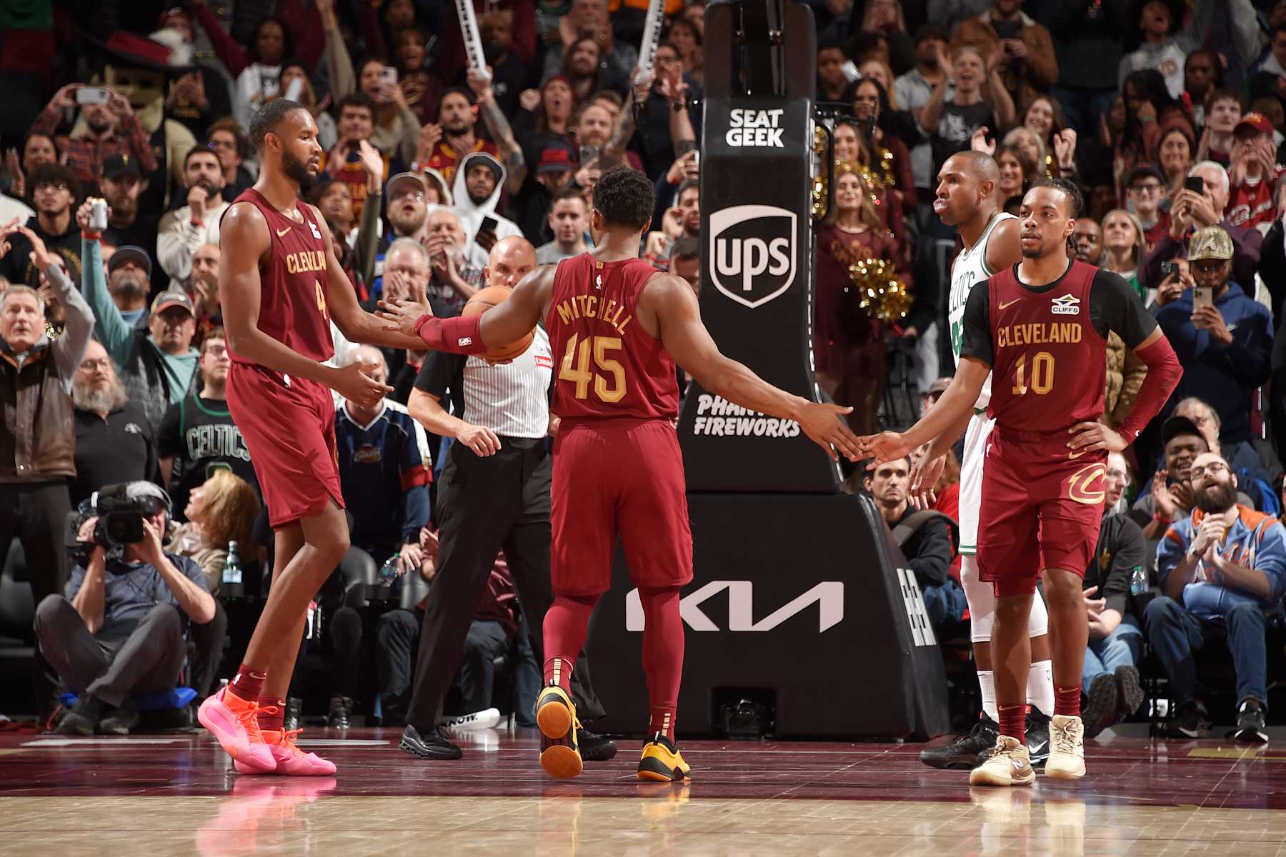 CLEVELAND, OH - DECEMBER 1: Donovan Mitchell #45, Evan Mobley #4 and Darius Garland #10 of the Cleveland Cavaliers high five during the game against the Boston Celtics on December 1, 2024 at Rocket Mortgage FieldHouse in Cleveland, Ohio. NOTE TO USER: User expressly acknowledges and agrees that, by downloading and/or using this Photograph, user is consenting to the terms and conditions of the Getty Images License Agreement. Mandatory Copyright Notice: Copyright 2024 NBAE (Photo by David Liam Kyle/NBAE via Getty Images)