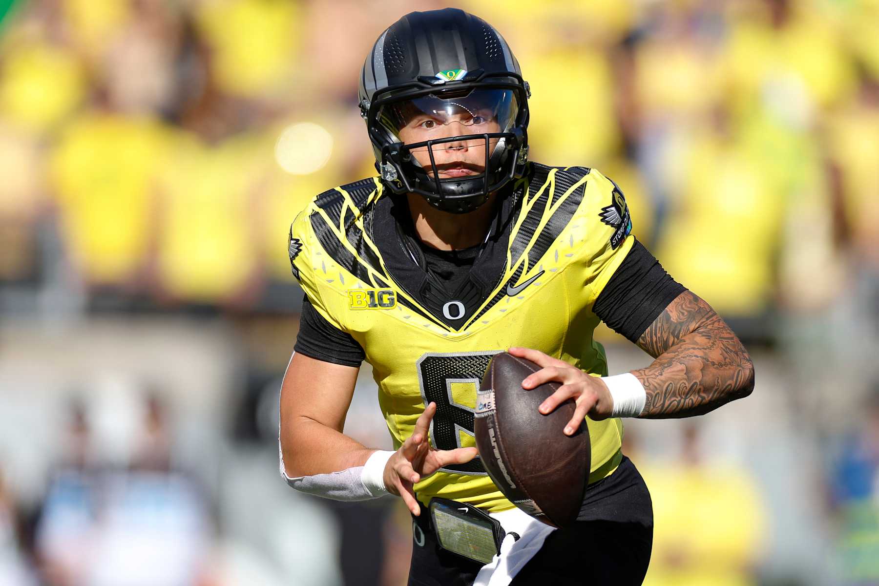 EUGENE, OREGON - OCTOBER 26: Dillon Gabriel #8 of the Oregon Ducks rolls out to throw a pass during the first half against the Illinois Fighting Illini at Autzen Stadium on October 26, 2024 in Eugene, Oregon. (Photo by Brandon Sloter/Image Of Sport/Getty Images)
