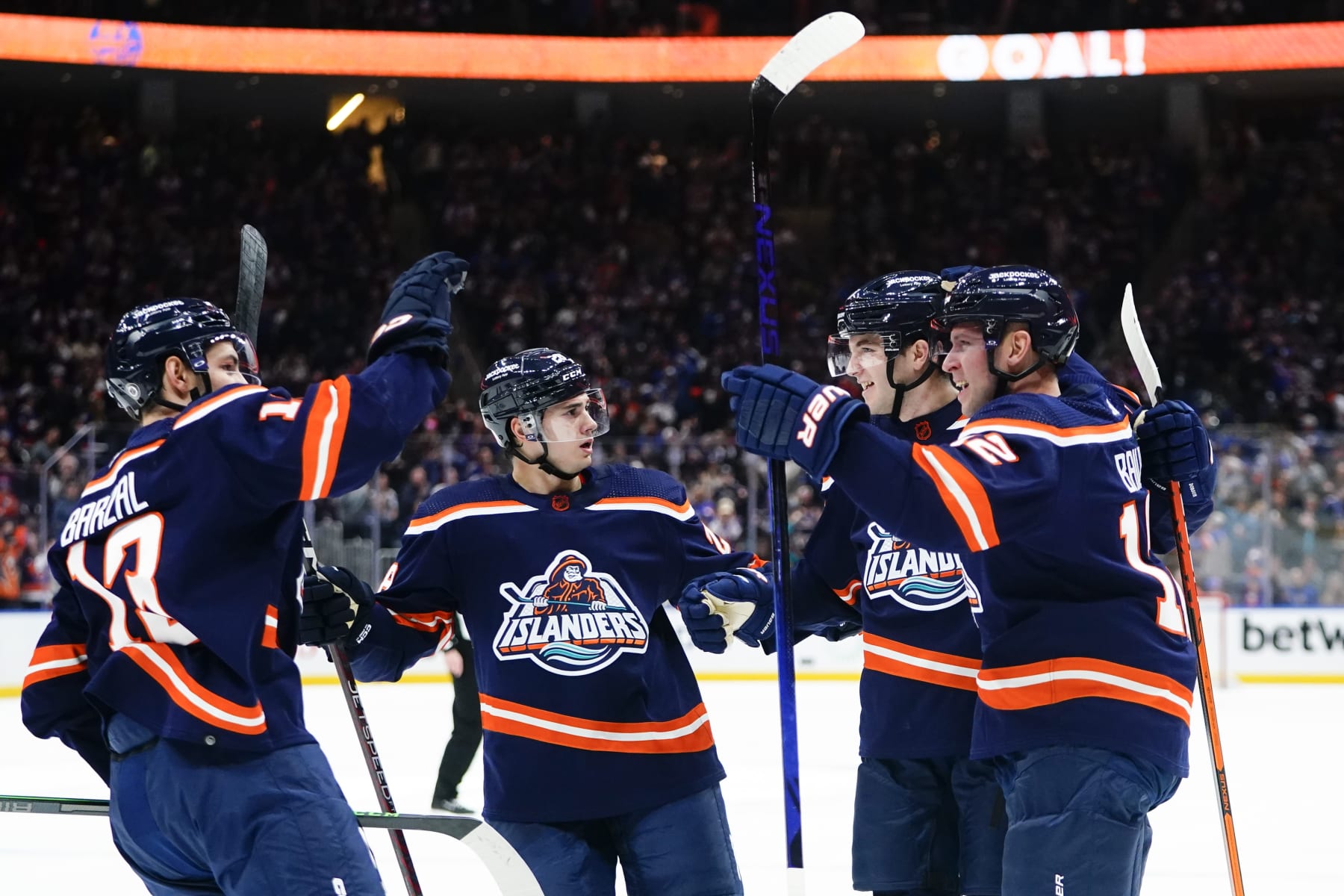 New York Islanders' Josh Bailey and Mathew Barzal celebrate with teammates after Bailey scored a goal during the second period of an NHL hockey game against the Pittsburgh Penguins, Tuesday, Dec. 27, 2022, in Elmont, N.Y. (AP Photo/Frank Franklin II)