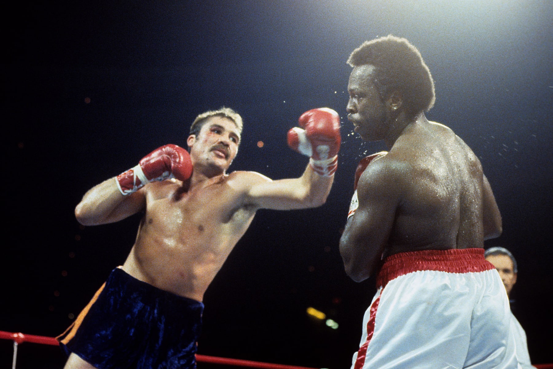 RICHFIELD,OH - SEPTEMBER 23,1983: Gerrie Coetzee (L) throws a left punch against Michael Dokes during the fight at the Richfield Coliseum in Richfield, Ohio. Gerrie Coetzee  won the WBA World heavyweight title by a KO 10. (Photo by: The Ring Magazine via Getty Images) 