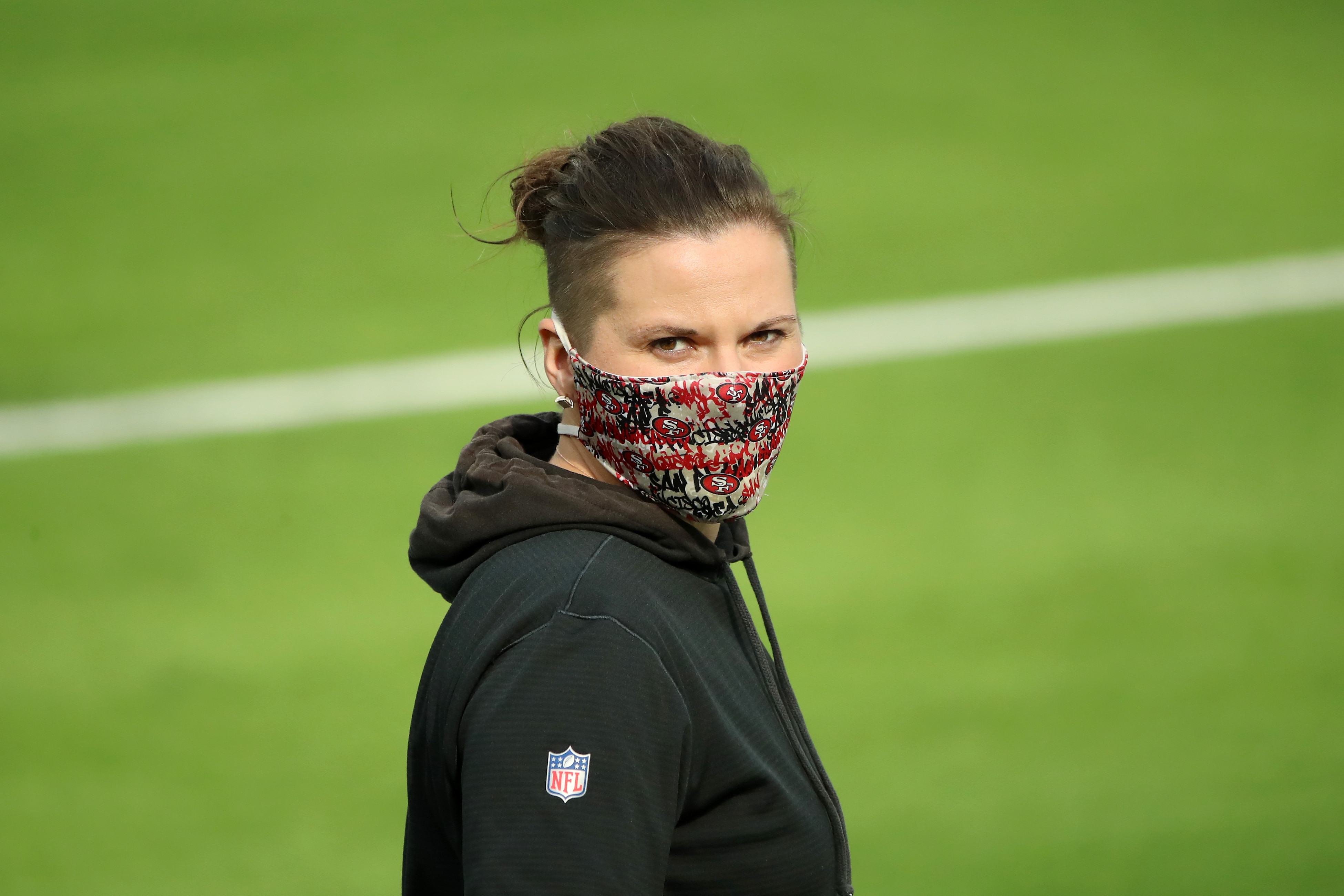 INGLEWOOD, CALIFORNIA - NOVEMBER 29: San Francisco 49ers offensive assistant Katie Sowers looks on during warm ups before the game between the San Francisco 49ers and the Los Angeles Rams at SoFi Stadium on November 29, 2020 in Inglewood, California. (Photo by Katelyn Mulcahy/Getty Images)