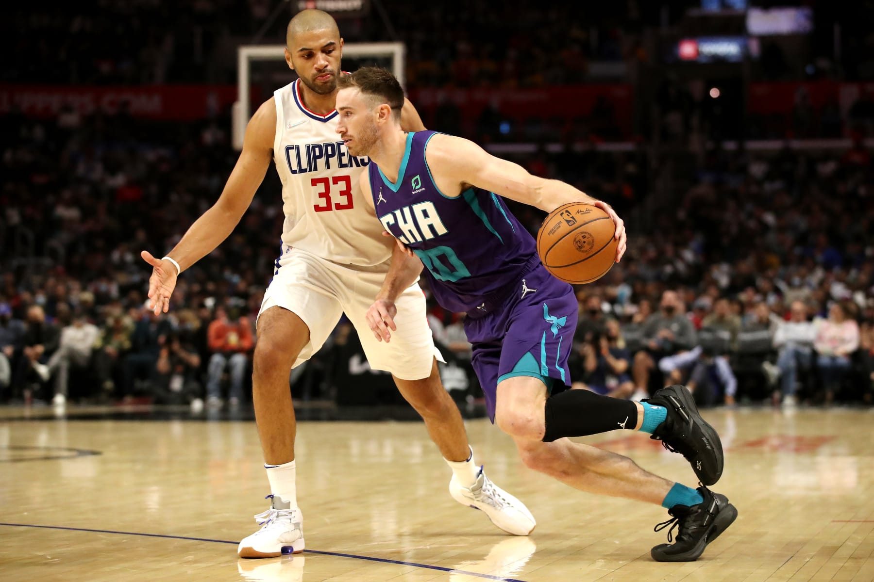 LOS ANGELES, CALIFORNIA - NOVEMBER 07: Gordon Hayward #20 of the Charlotte Hornets drives to the basket against Nicolas Batum #33 of the Los Angeles Clippers during the third quarter at Staples Center on November 07, 2021 in Los Angeles, California. NOTE TO USER: User expressly acknowledges and agrees that, by downloading and or using this photograph, User is consenting to the terms and conditions of the Getty Images License Agreement. (Photo by Katelyn Mulcahy/Getty Images)