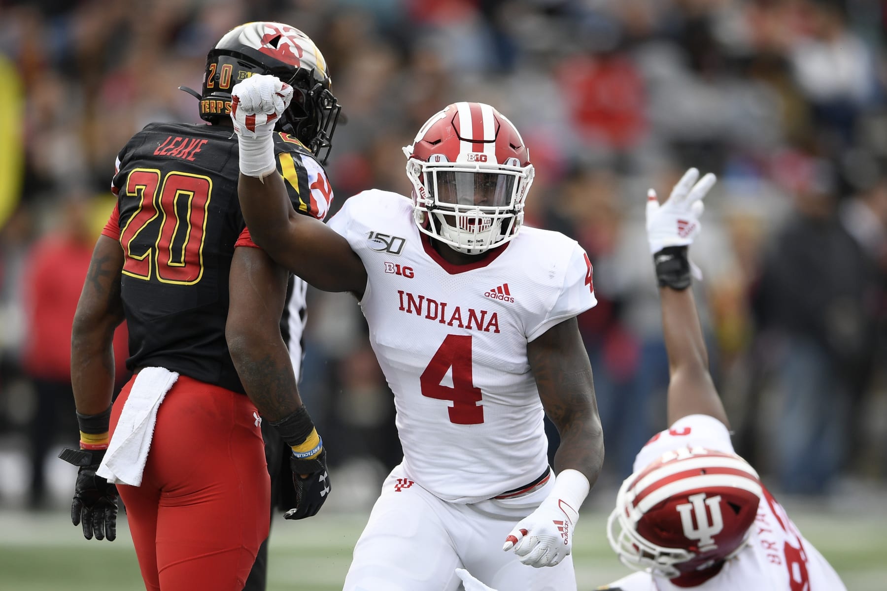 Indiana linebacker Cam Jones (4) reacts as his team stopped Maryland on a fourth down play during the first half of an NCAA college football game, Saturday, Oct. 19, 2019, in College Park, Md. Maryland running back Javon Leake (20) looks on. (AP Photo/Nick Wass)