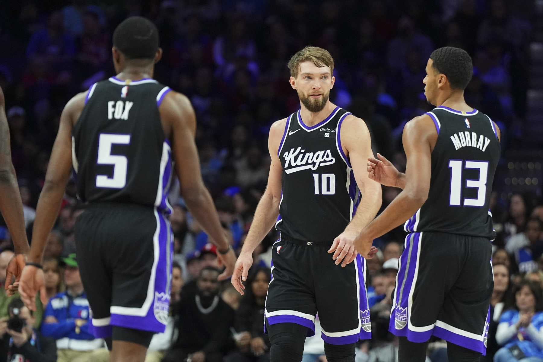 PHILADELPHIA, PENNSYLVANIA - JANUARY 12: De'Aaron Fox #5, Domantas Sabonis #10, and Keegan Murray #13 of the Sacramento Kings look on against the Philadelphia 76ers at the Wells Fargo Center on January 12, 2024 in Philadelphia, Pennsylvania. NOTE TO USER: User expressly acknowledges and agrees that, by downloading and or using this photograph, User is consenting to the terms and conditions of the Getty Images License Agreement. (Photo by Mitchell Leff/Getty Images)