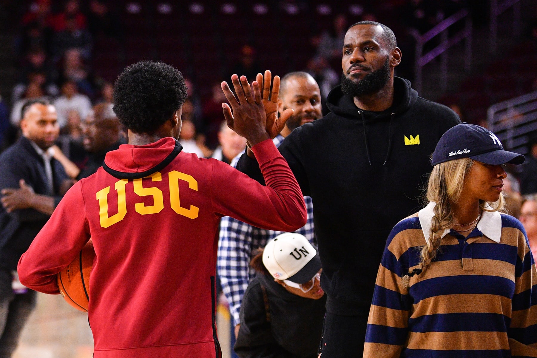 LOS ANGELES, CA - JANUARY 06: USC Trojans guard Bronny James (6) give his dad Lebron James a high five before the college basketball game between the Stanford Cardinal and the USC Trojans on January 6, 2024 at Galen Center in Los Angeles, CA. (Photo by Brian Rothmuller/Icon Sportswire via Getty Images)