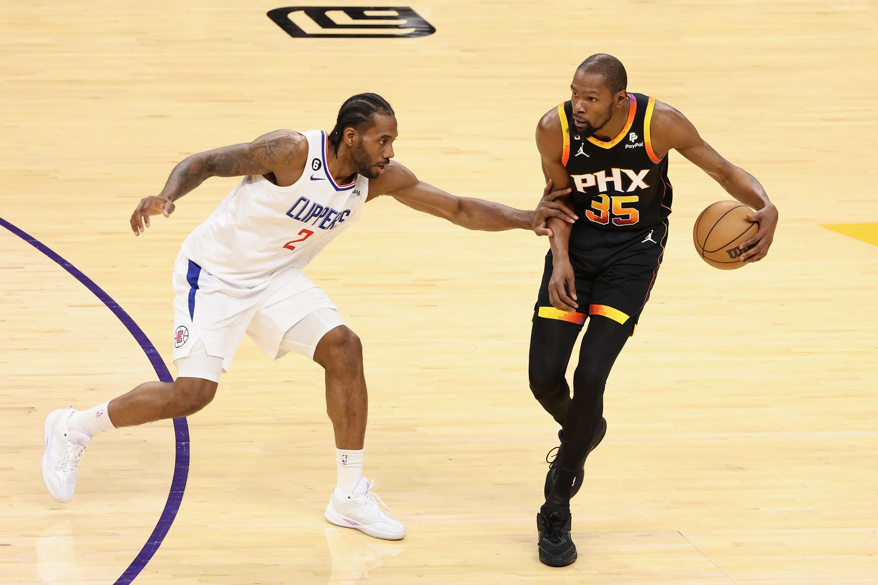 PHOENIX, ARIZONA - APRIL 18: Kevin Durant #35 of the Phoenix Suns handles the ball against Kawhi Leonard #2 of the LA Clippers during the first half of Game Two of the Western Conference First Round Playoffs at Footprint Center on April 18, 2023 in Phoenix, Arizona. NOTE TO USER: User expressly acknowledges and agrees that, by downloading and or using this photograph, User is consenting to the terms and conditions of the Getty Images License Agreement. (Photo by Christian Petersen/Getty Images)