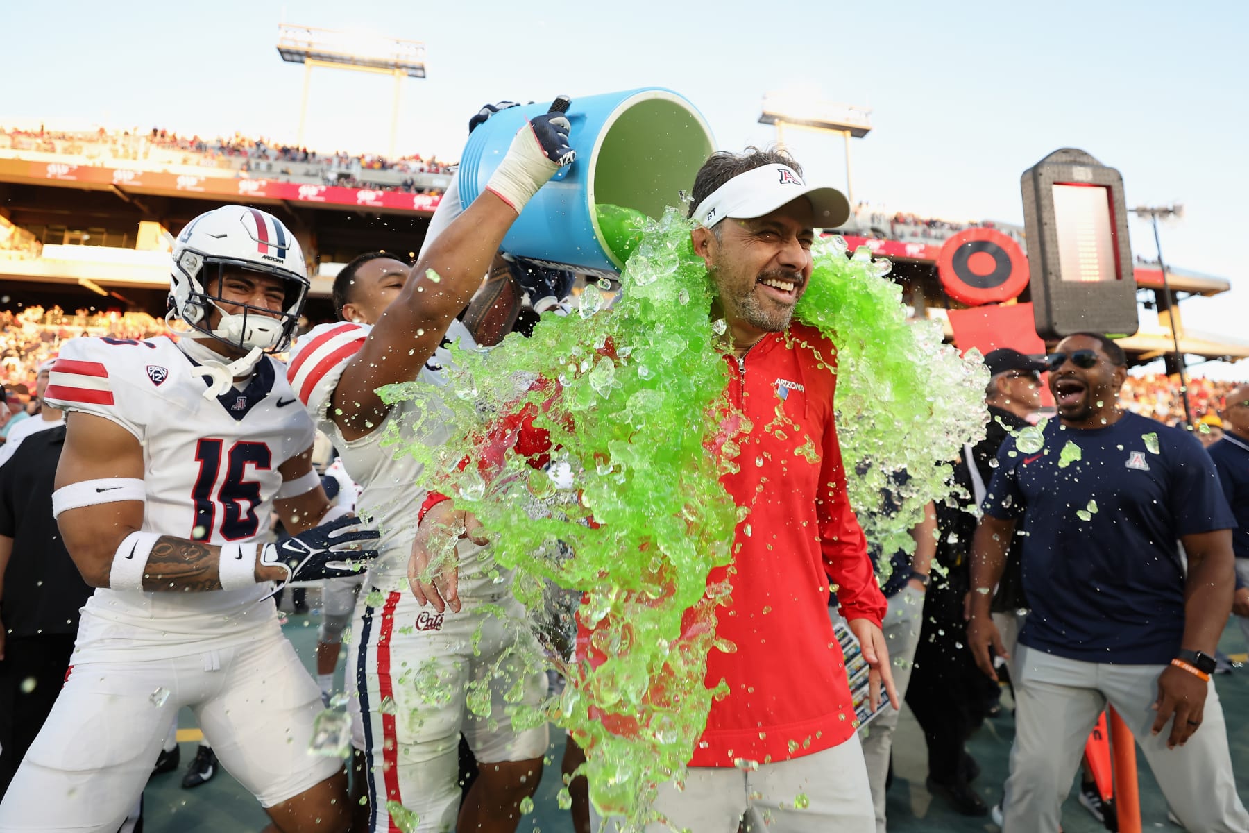 TEMPE, ARIZONA - NOVEMBER 25: Head coach Jedd Fisch of the Arizona Wildcats is dunked with powerade during the final moments of the NCAAF game against the Arizona State Sun Devils at Mountain America Stadium on November 25, 2023 in Tempe, Arizona. The Wildcats defeated the Sun Devils 59-23. (Photo by Christian Petersen/Getty Images) TEMPE, ARIZONA - NOVEMBER 25: Head coach Jedd Fisch of the Arizona Wildcats is dunked with powerade during the final moments of the NCAAF game against the Arizona State Sun Devils at Mountain America Stadium on November 25, 2023 in Tempe, Arizona. The Wildcats defeated the Sun Devils 59-23. (Photo by Christian Petersen/Getty Images)