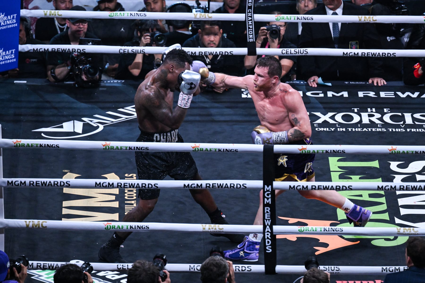 LAS VEGAS, NV - SEPTEMBER 30: Canelo Alvarez (in purple and yellow short) and Jermell Charlo (in black short) exchange punches during their super middleweight world titles of the Premiere Boxing Championship on Saturday night at the T-Mobile Arena in Las Vegas, Nevada, United States on September 30, 2023. (Photo by Tayfun Coskun/Anadolu Agency via Getty Images)