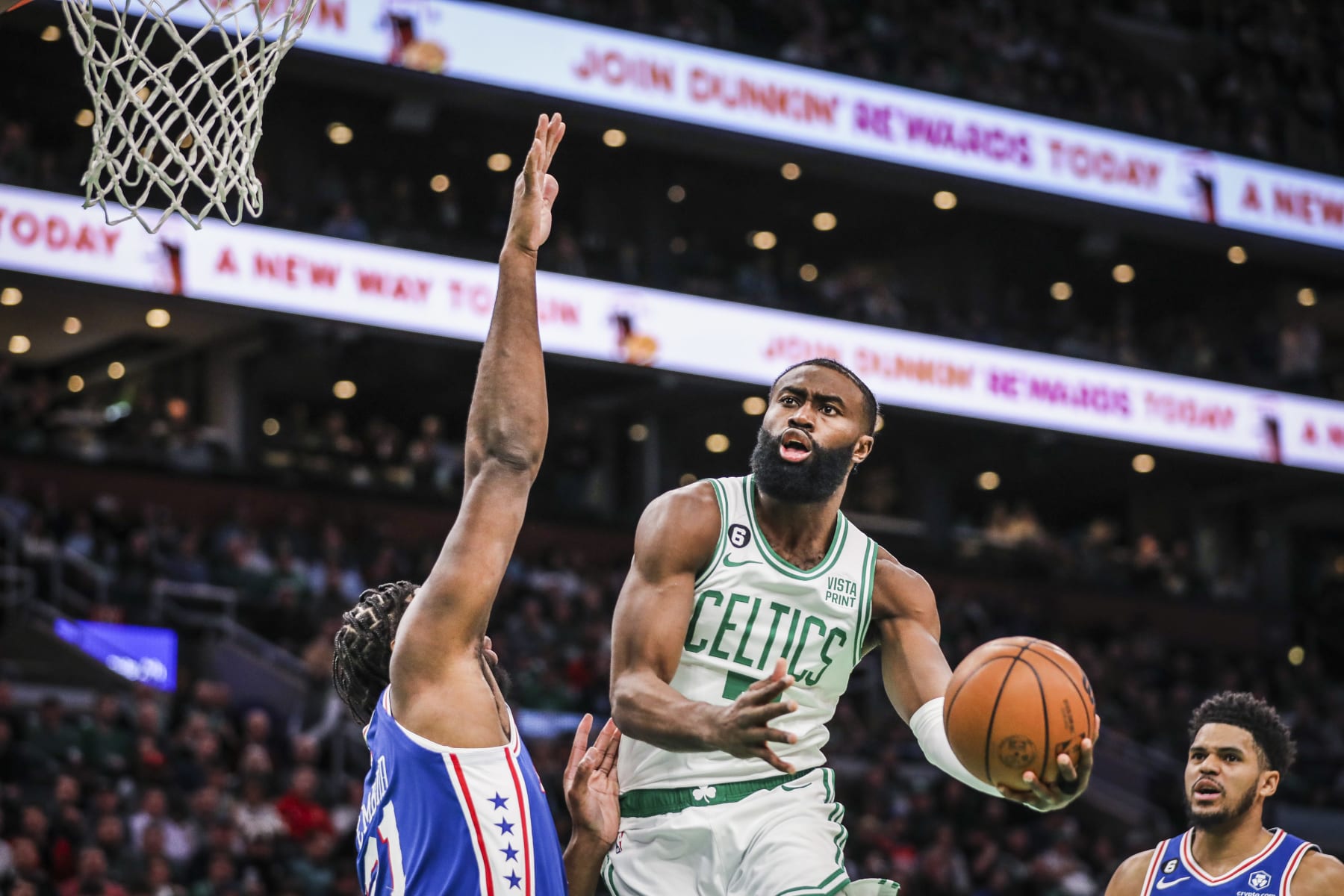 Boston, MA - February 8: Boston Celtics SG Jaylen Brown tries an under-handed shot against the defense of Philadelphia 76ers C Joel Embiid. The Celtics beat the 76ers, 106-99. (Photo by Erin Clark/The Boston Globe via Getty Images)
