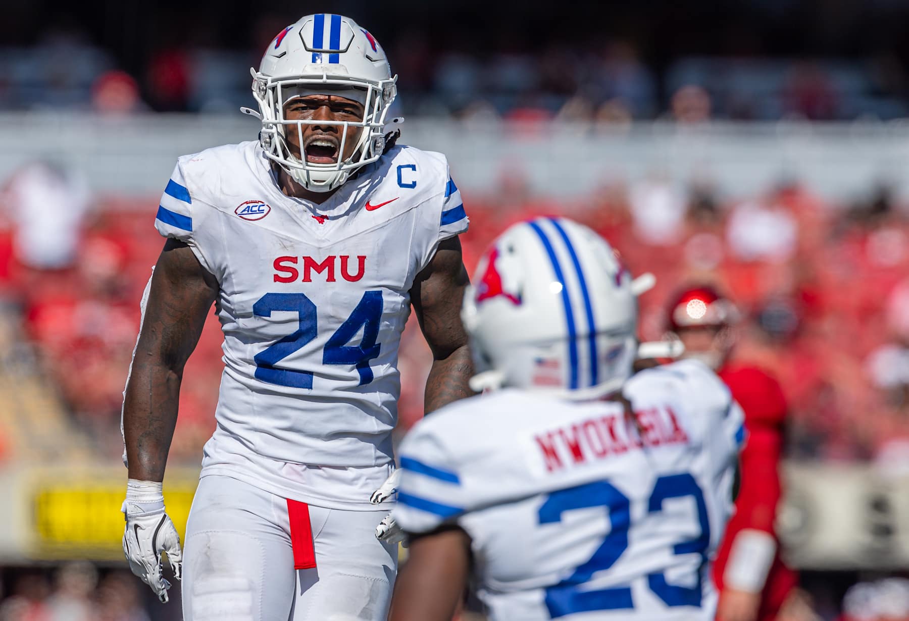 Kobe Wilson #24 celebrates with Isaiah Nwokobia #23 of the Southern Methodist Mustangs 
