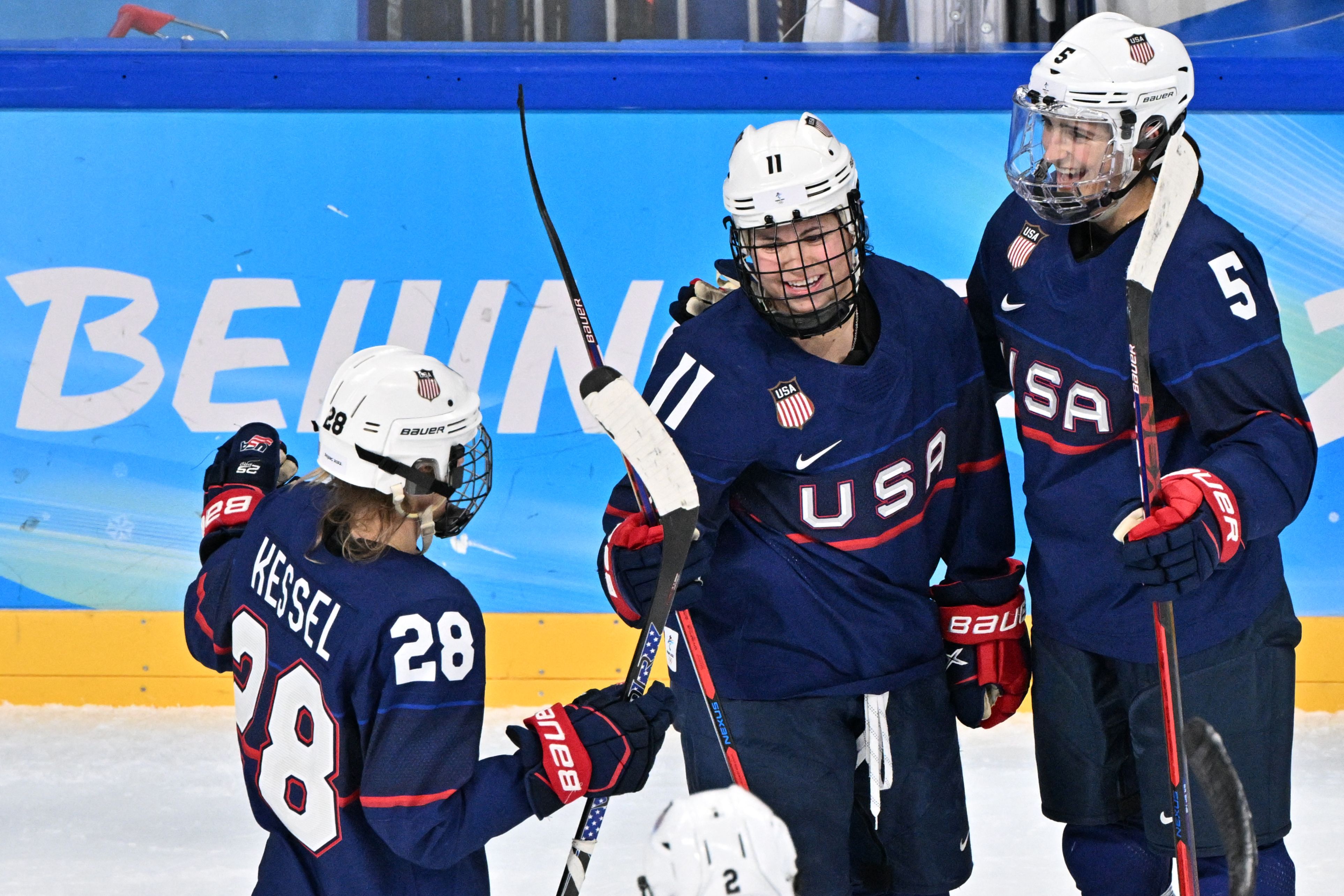 USA's Abby Roque (C) celebrates with teammates after scoring her side's 4th goal during the women's play-offs semifinal match of the Beijing 2022 Winter Olympic Games ice hockey competition between USA and Finland, at the Wukesong Sports Centre in Beijing on February 14, 2022. (Photo by ANTHONY WALLACE / AFP) (Photo by ANTHONY WALLACE/AFP via Getty Images)