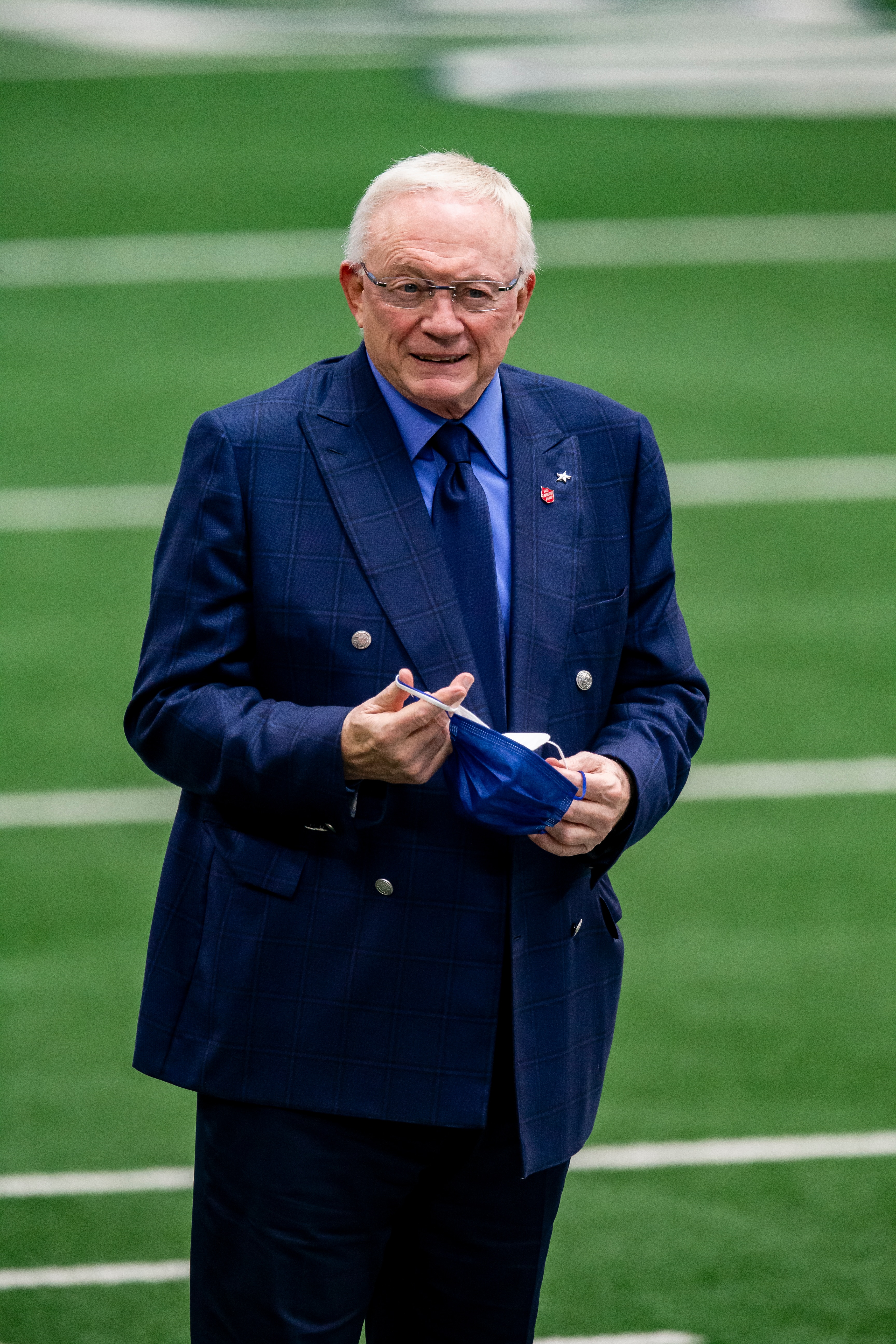 Dallas Cowboys owner Jerry Jones puts on a mask before an NFL football game against the Pittsburgh Steelers, Sunday, Nov. 8, 2020, in Arlington, Texas. Pittsburgh won 24-19. (AP Photo/Brandon Wade)