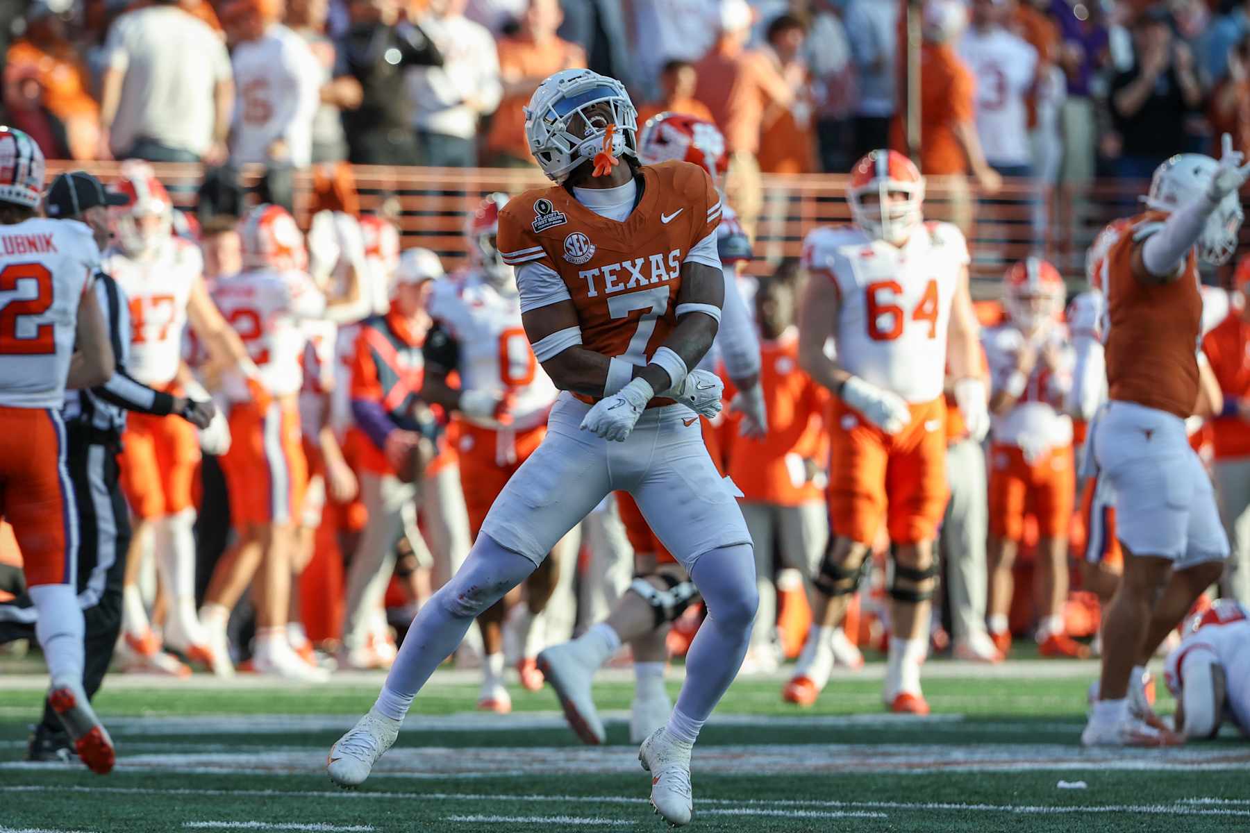 AUSTIN, TX - DECEMBER 21: Texas Longhorns defensive back Jahdae Barron (7) celebrates an interception by teammate Texas Longhorns linebacker Colin Simmons (11) (not shown) during the CFP First Round game between Texas Longhorns and Clemson Tigers on December 21, 2024, at Darrell K Royal - Texas Memorial Stadium in Austin, TX. (Photo by David Buono/Icon Sportswire via Getty Images)