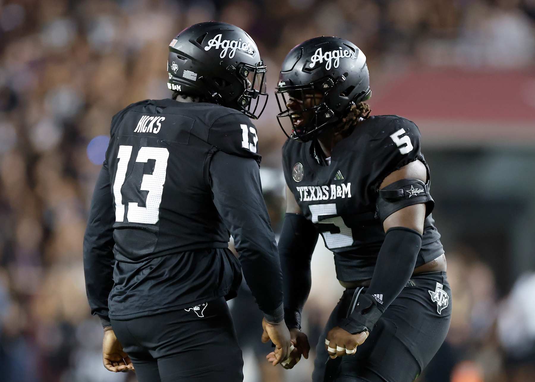 DJ Hicks #13 of the Texas A&M Aggies celebrates with Shemar Turner #5
