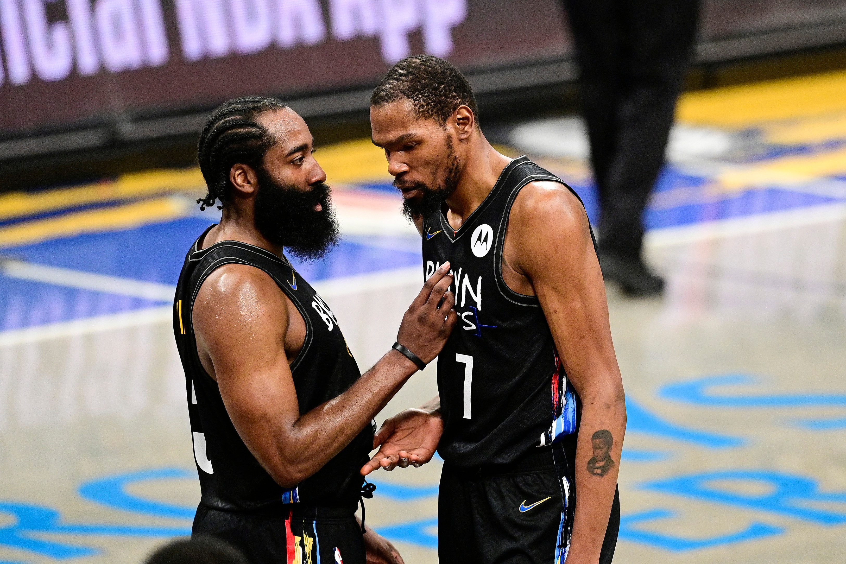 NEW YORK, NEW YORK - JUNE 01:  James Harden #13 and Kevin Durant #7 of the Brooklyn Nets speak during a timeout against the Boston Celtics in Game Five of the First Round of the 2021 NBA Playoffs at Barclays Center on June 01, 2021 in the Brooklyn borough of New York City. NOTE TO USER: User expressly acknowledges and agrees that, by downloading and or using this photograph, User is consenting to the terms and conditions of the Getty Images License Agreement. (Photo by Steven Ryan/Getty Images)