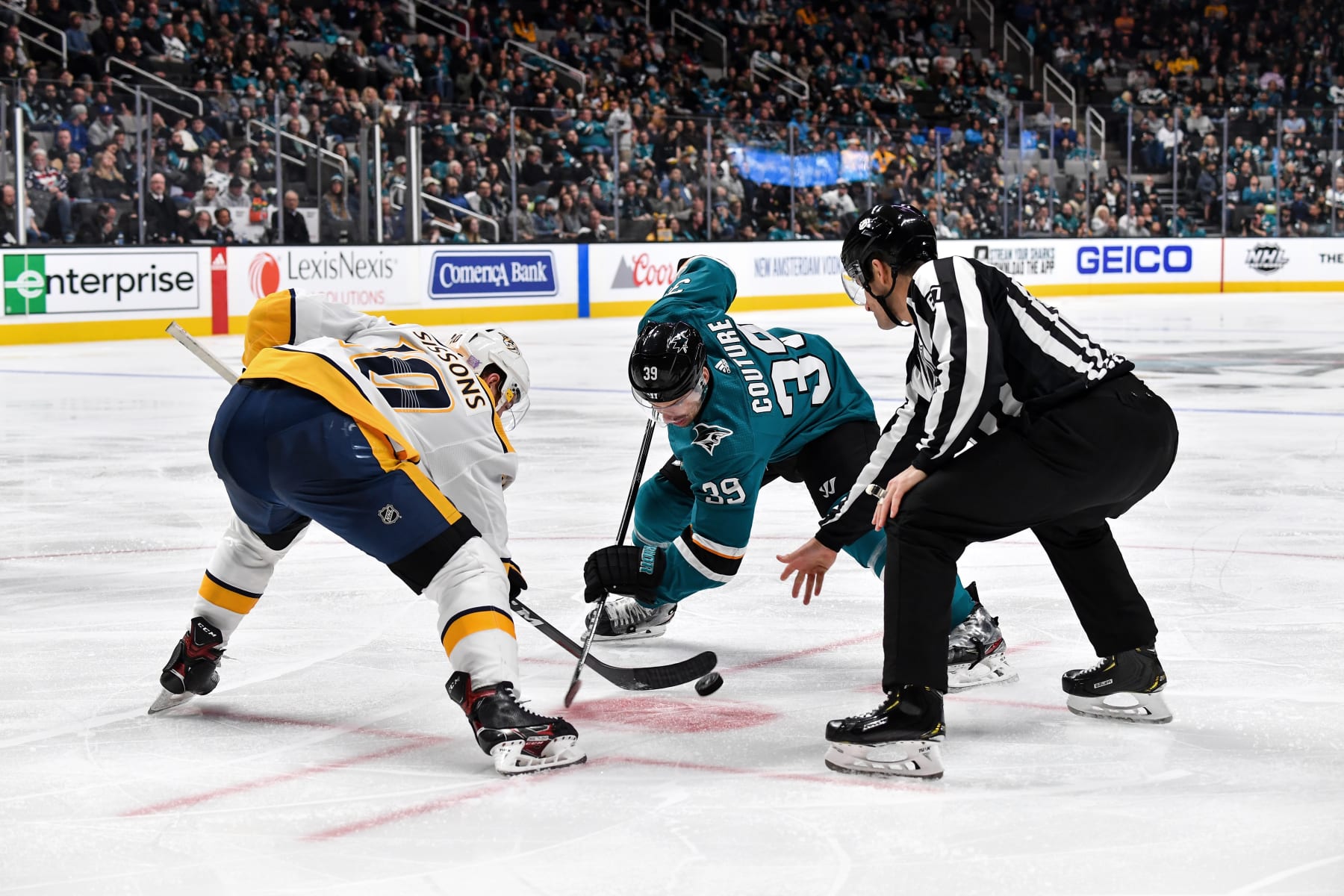 SAN JOSE, CA - NOVEMBER 9: Logan Couture #39 of the San Jose Sharks takes a face-off against Colton Sissons #10 of the Nashville Predators at SAP Center on November 9, 2019 in San Jose, California. (Photo by Brandon Magnus/NHLI via Getty Images)