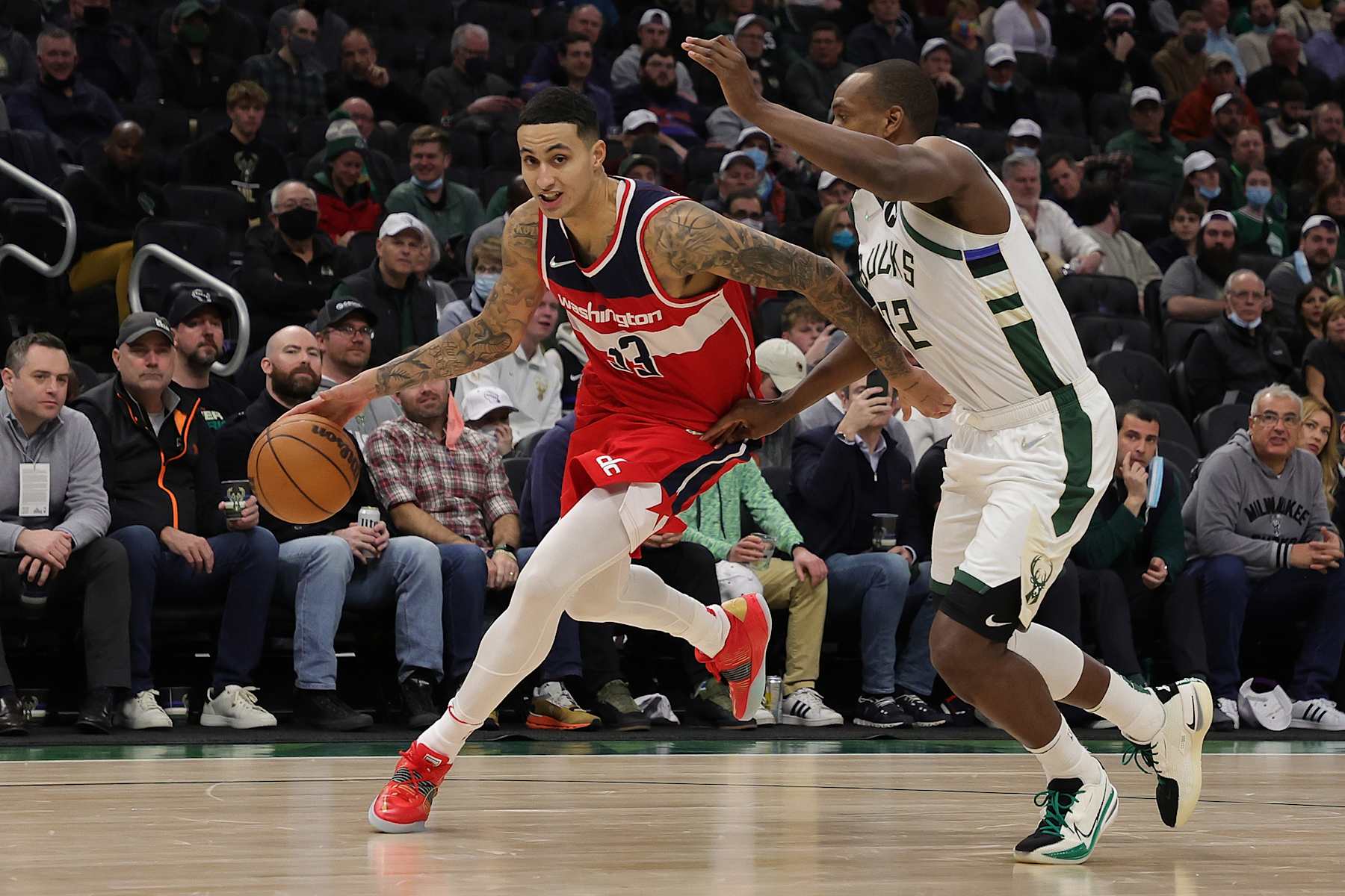 MILWAUKEE, WISCONSIN - FEBRUARY 01: Kyle Kuzma #33 of the Washington Wizards drives around Khris Middleton #22 of the Milwaukee Bucks during the second half of a game at Fiserv Forum on February 01, 2022 in Milwaukee, Wisconsin. NOTE TO USER: User expressly acknowledges and agrees that, by downloading and or using this photograph, User is consenting to the terms and conditions of the Getty Images License Agreement. (Photo by Stacy Revere/Getty Images)