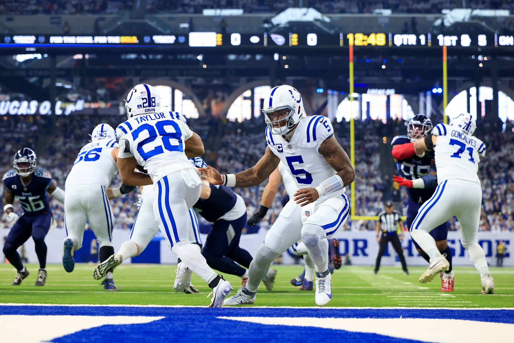 Indianapolis Colts quarterback Anthony Richardson hands the ball to running back Jonathan Taylor.
