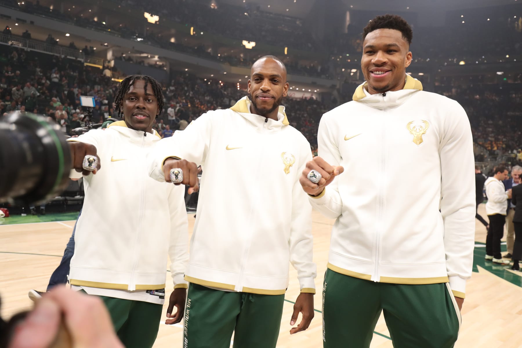 MILWAUKEE, WI - OCTOBER 19: Jrue Holiday #21, Khris Middleton #22 and Giannis Antetokounmpo #34 of the Milwaukee Bucks pose for a photo with their 2021 NBA Championship Rings before the game against the Brooklyn Nets on October 19, 2021 at the Fiserv Forum Center in Milwaukee, Wisconsin. NOTE TO USER: User expressly acknowledges and agrees that, by downloading and or using this Photograph, user is consenting to the terms and conditions of the Getty Images License Agreement. Mandatory Copyright Notice: Copyright 2021 NBAE (Photo by Nathaniel S. Butler/NBAE via Getty Images).