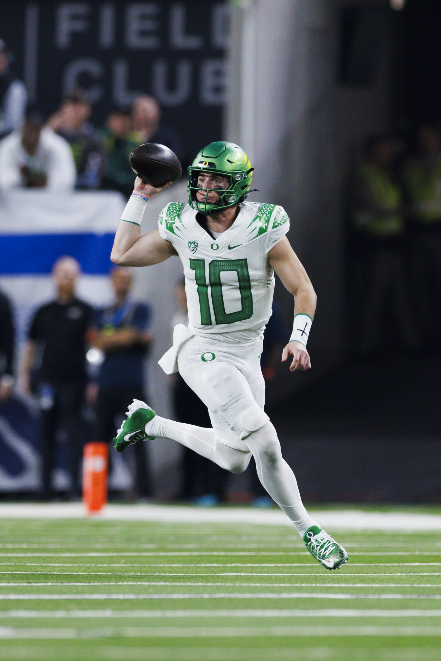 LAS VEGAS, NEVADA - DECEMBER 1: Bo Nix #10 of the Oregon Ducks rolls out to pass against the Washington Huskies during the Pac-12 Championship at Allegiant Stadium on December 1, 2023 in Las Vegas, Nevada. (Photo by Ric Tapia/Getty Images)
