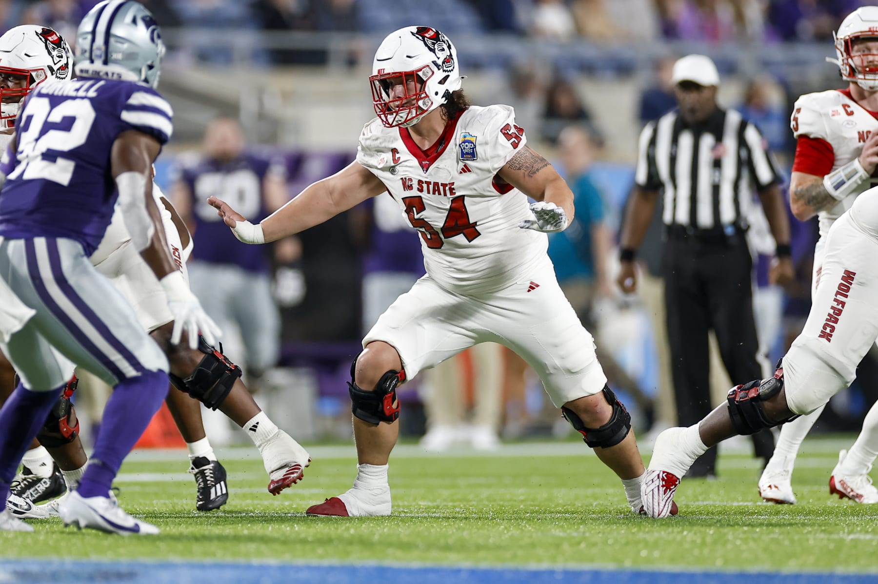 ORLANDO, FL - DECEMBER 28: North Carolina State Wolfpack offensive lineman Dylan McMahon (54) /blocls during the game between the North Carolina State Wolfpack and the Kansas State Wildcats on December 28, 2023 at Camping World Stadium in Orlando, Fl. (Photo by David Rosenblum/Icon Sportswire via Getty Images)