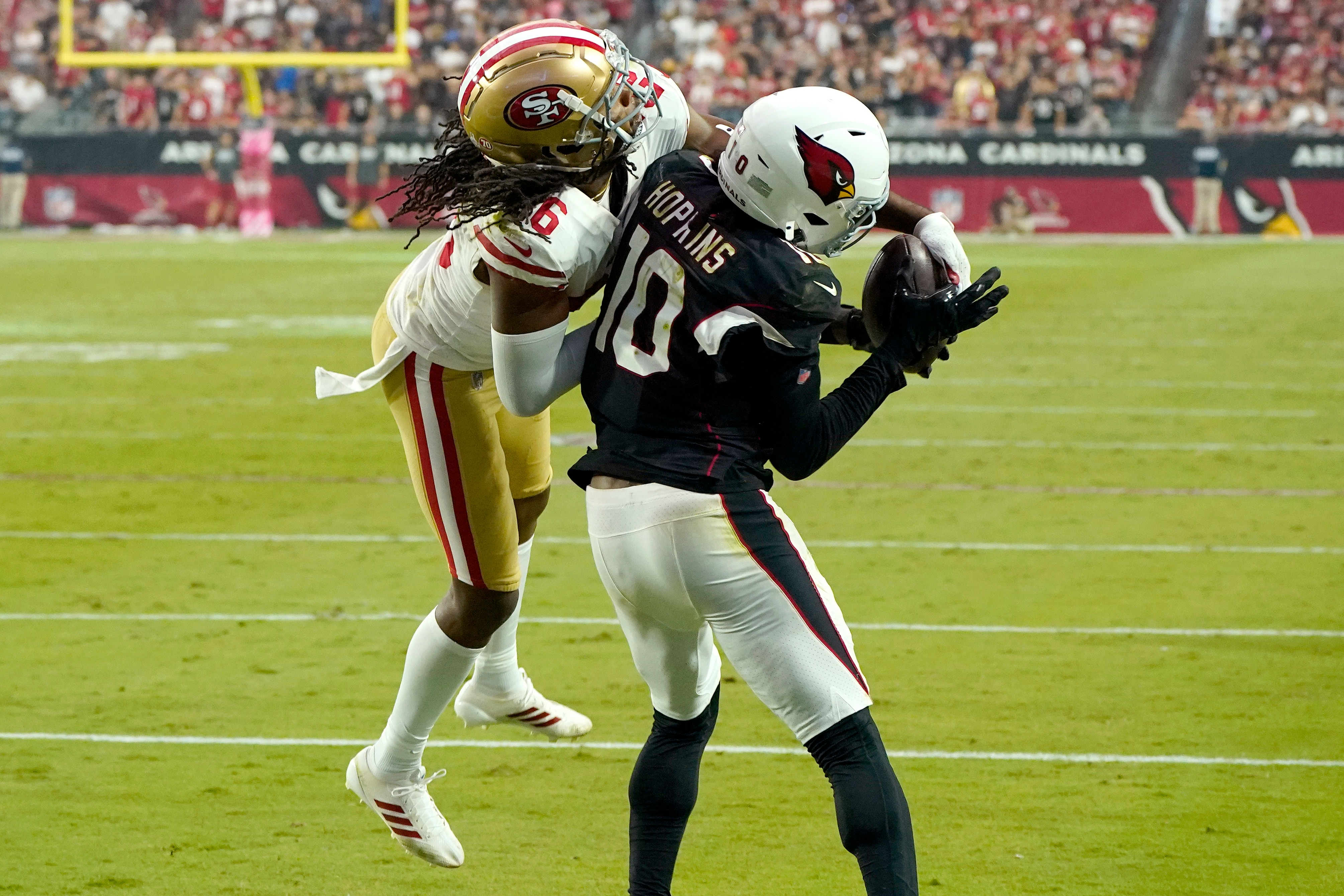 Arizona Cardinals wide receiver DeAndre Hopkins (10) pulls in a touchdown pass as San Francisco 49ers cornerback Josh Norman (26) defends during the second half of an NFL football game, Sunday, Oct. 10, 2021, in Glendale, Ariz. (AP Photo/Darryl Webb)