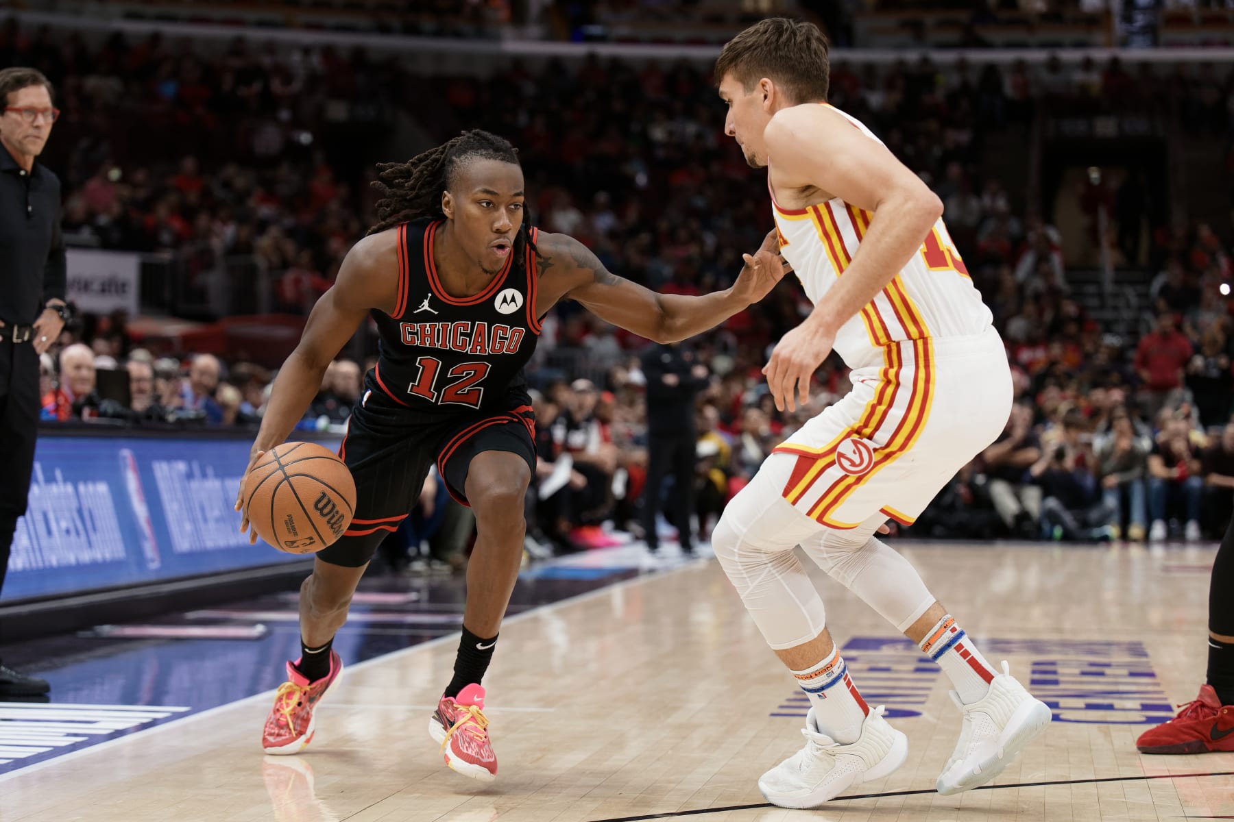 CHICAGO, ILLINOIS - APRIL 17:  Ayo Dosunmu #12 of the Chicago Bulls controls the ball against the Atlanta Hawks on April 17, 2024 at United Center in Chicago, Illinois.   NOTE TO USER: User expressly acknowledges and agrees that, by downloading and or using this photograph, User is consenting to the terms and conditions of the Getty Images License Agreement.  (Photo by Jamie Sabau/Getty Images)