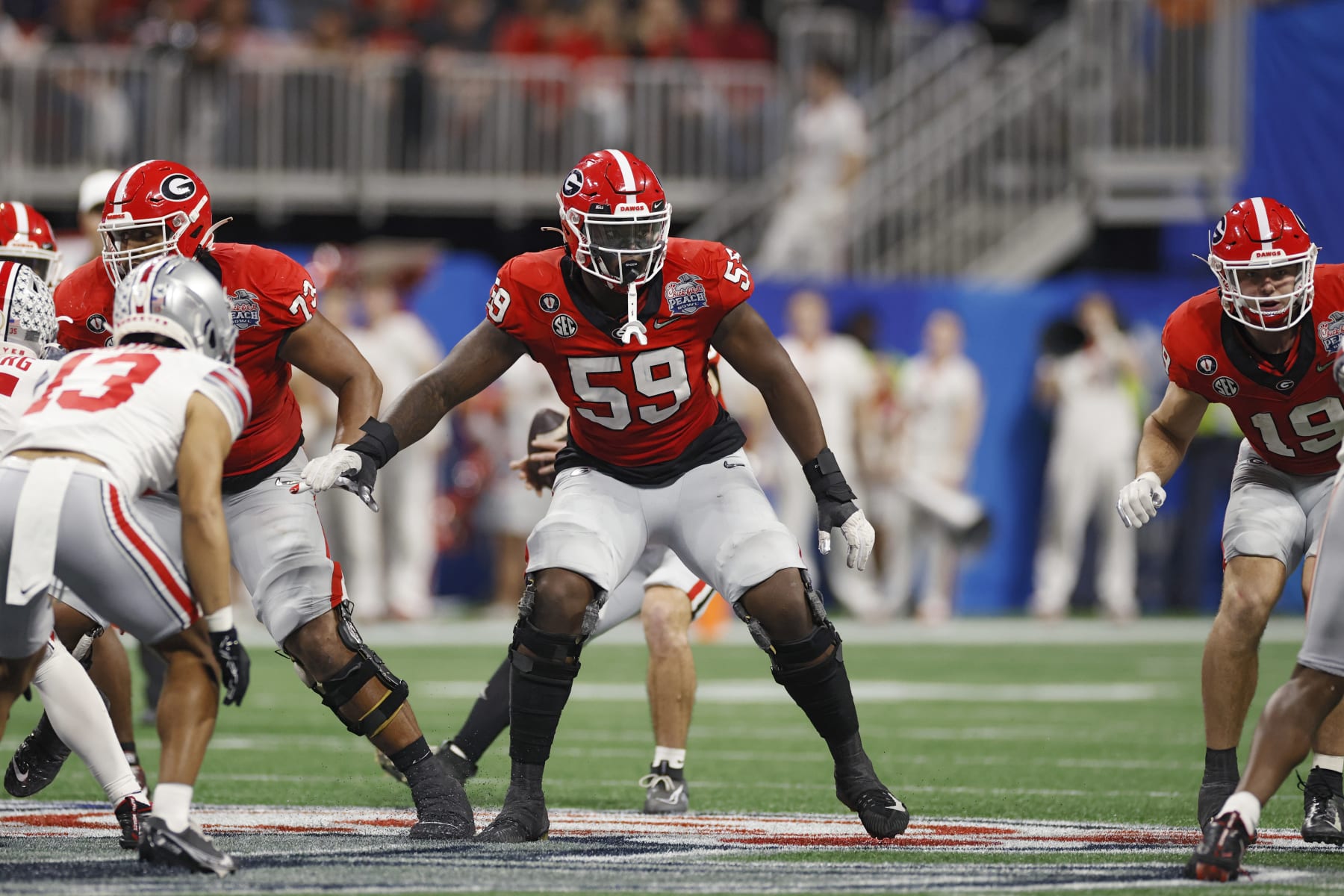 ATLANTA, GA - DECEMBER 31: Georgia Bulldogs offensive lineman Broderick Jones (59) blocks during the Chick-fil-A Peach Bowl semifinal game against the Ohio State Buckeyes on December 31, 2022 at Mercedes-Benz Stadium in Atlanta, Georgia. (Photo by Joe Robbins/Icon Sportswire via Getty Images)