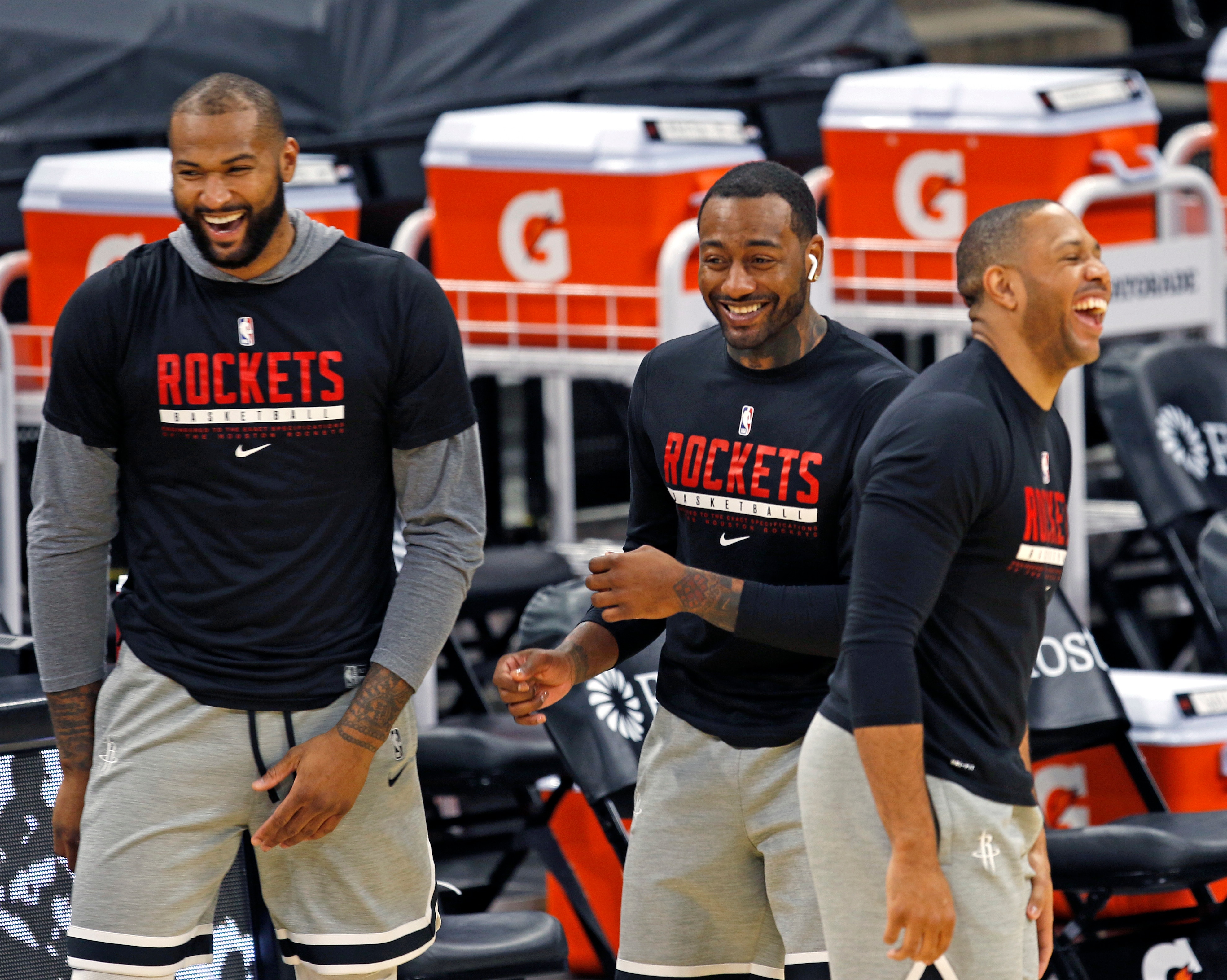 SAN ANTONIO, TX - JANUARY 16:  DeMarcus Cousins #15 of the Houston Rockets, John Wall #1, and Eric Gordon #10 share a light moment before the start of their game against the San Antonio Spurs at AT&T Center on January 16, 2021 in San Antonio, Texas.  NOTE TO USER: User expressly acknowledges and agrees that , by downloading and or using this photograph, User is consenting to the terms and conditions of the Getty Images License Agreement. (Photo by Ronald Cortes/Getty Images)