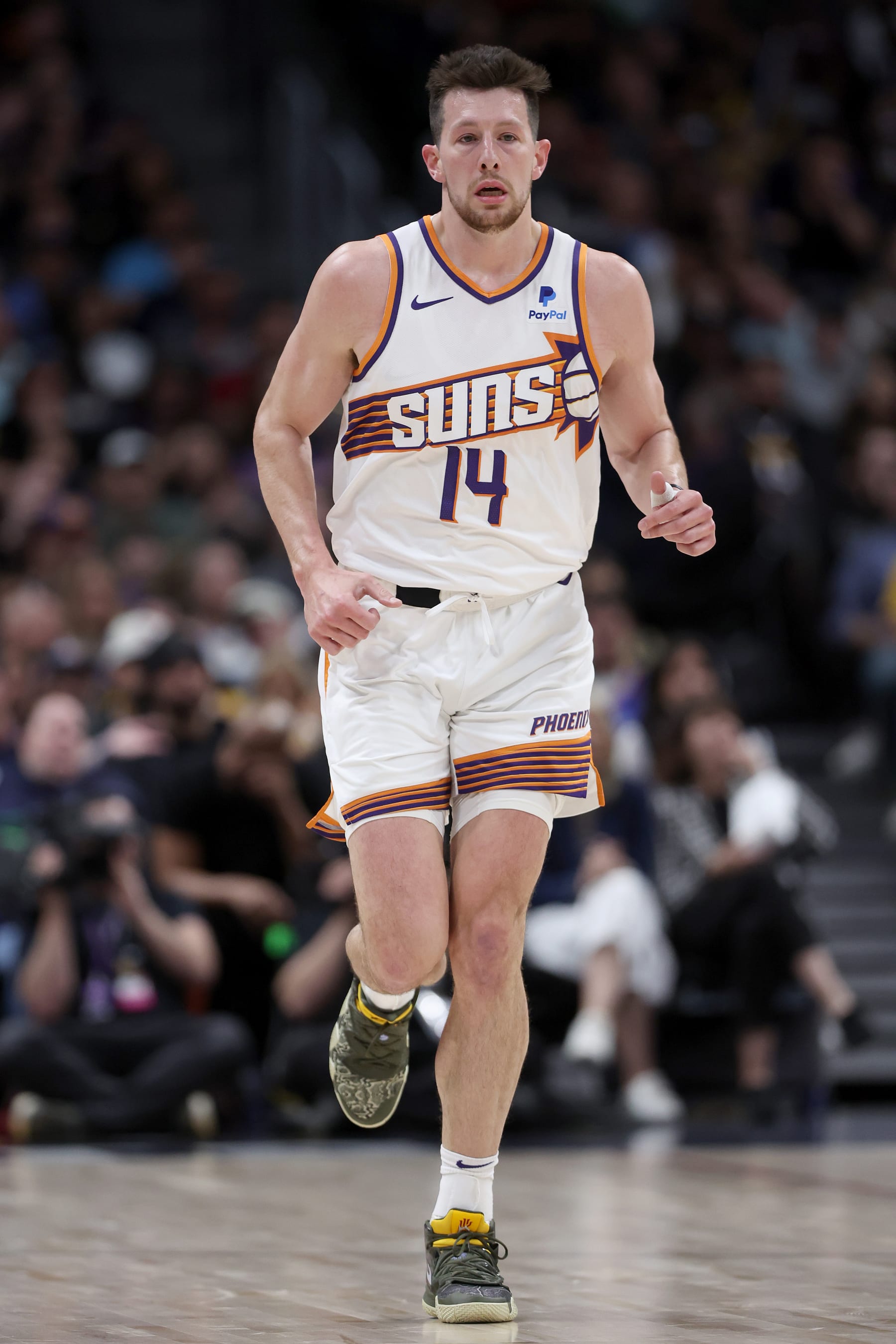 DENVER, COLORADO - MARCH 27: Drew Eubanks #14 of the Phoenix Suns plays the Denver Nuggets during the first quarter at Ball Arena on March 27, 2024 in Denver, Colorado. NOTE TO USER: User expressly acknowledges and agrees that, by downloading and or using this photograph, User is consenting to the terms and conditions of the Getty Images License Agreement.  (Photo by Matthew Stockman/Getty Images)