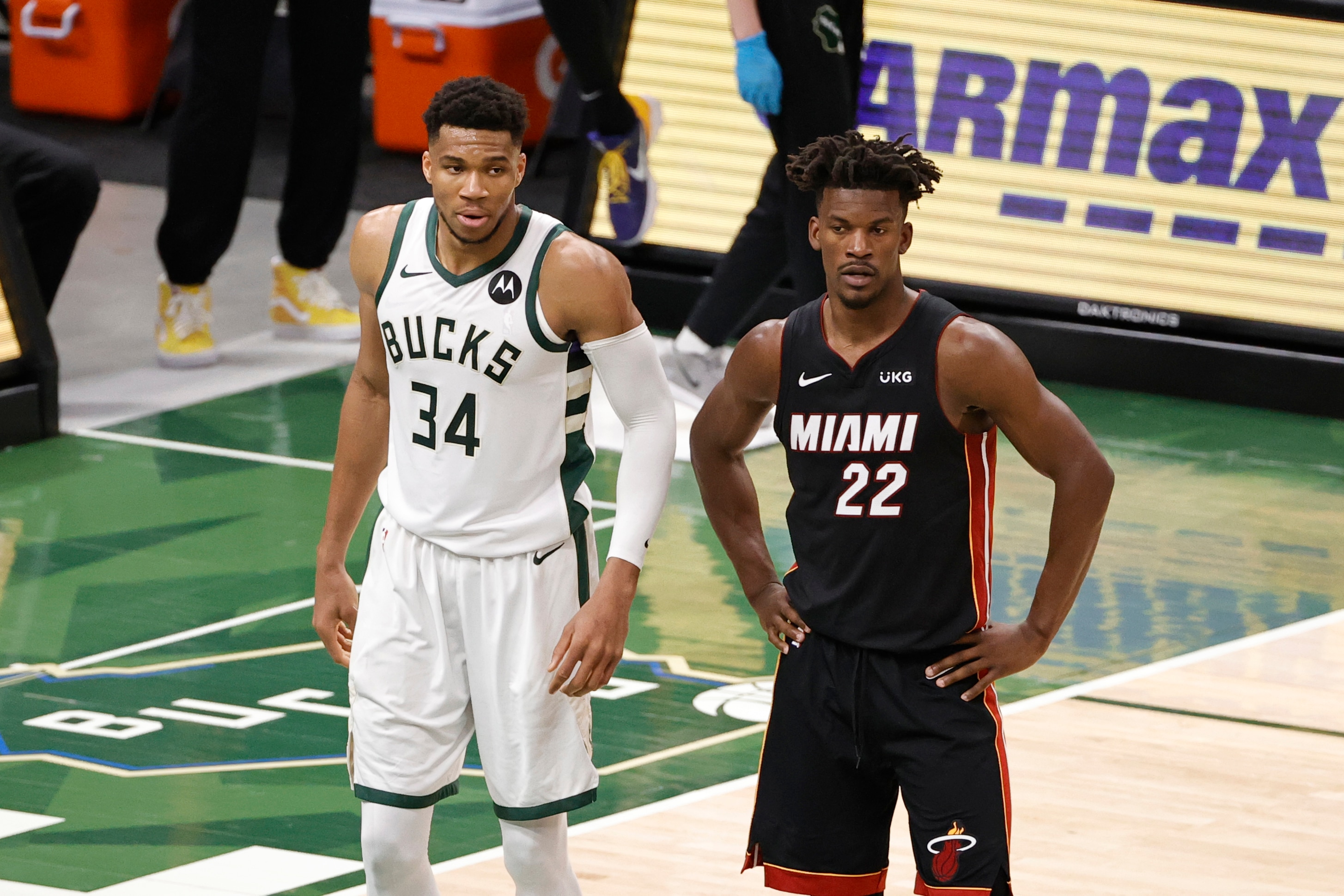 MILWAUKEE, WI - MAY 24: Giannis Antetokounmpo #34 of the Milwaukee Bucks and Jimmy Butler #22 of the Miami Heat look on during Round 1, Game 2 of the 2021 NBA Playoffs on May 24, 2021 at the Fiserv Forum Center in Milwaukee, Wisconsin. NOTE TO USER: User expressly acknowledges and agrees that, by downloading and or using this Photograph, user is consenting to the terms and conditions of the Getty Images License Agreement. Mandatory Copyright Notice: Copyright 2021 NBAE (Photo by Kamil Krzaczynski/NBAE via Getty Images).