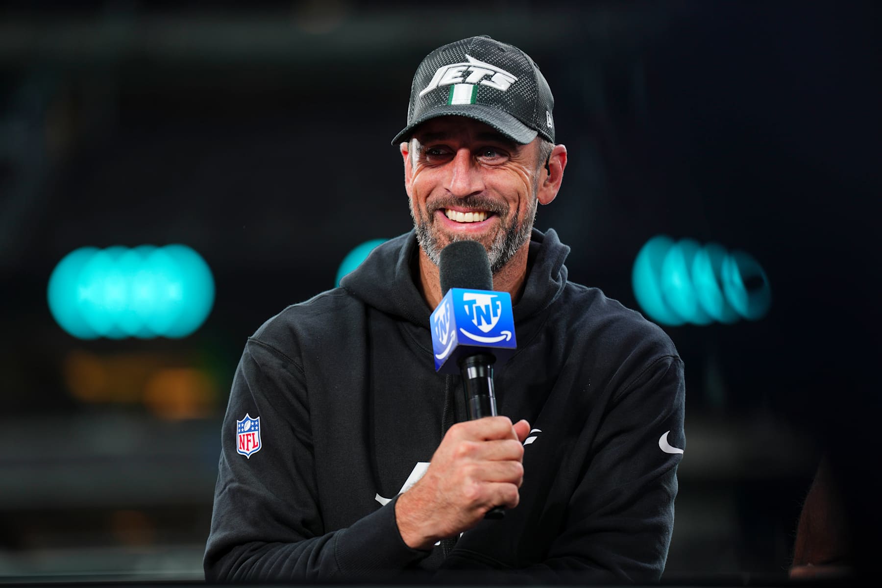 EAST RUTHERFORD, NJ - OCTOBER 31: Aaron Rodgers #8 of the New York Jets visits on set of the TNF on Prime postgame show after an NFL football game between the Houston Texans and the New York Jets at MetLife Stadium on October 31, 2024 in East Rutherford, New Jersey. (Photo by Cooper Neill/Getty Images)