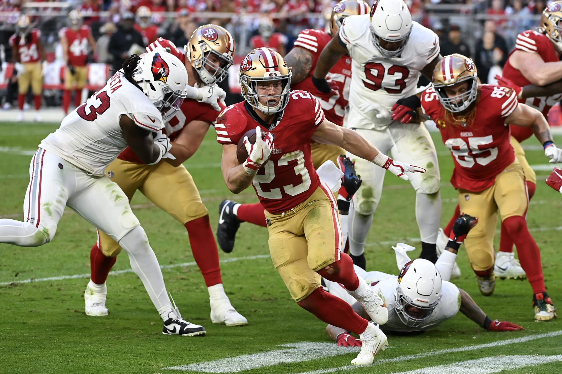 GLENDALE, ARIZONA - DECEMBER 17: Christian McCaffrey #23 of the San Francisco 49ers runs with the ball during the fourth quarter of a game against the Arizona Cardinals at State Farm Stadium on December 17, 2023 in Glendale, Arizona. (Photo by Norm Hall/Getty Images)