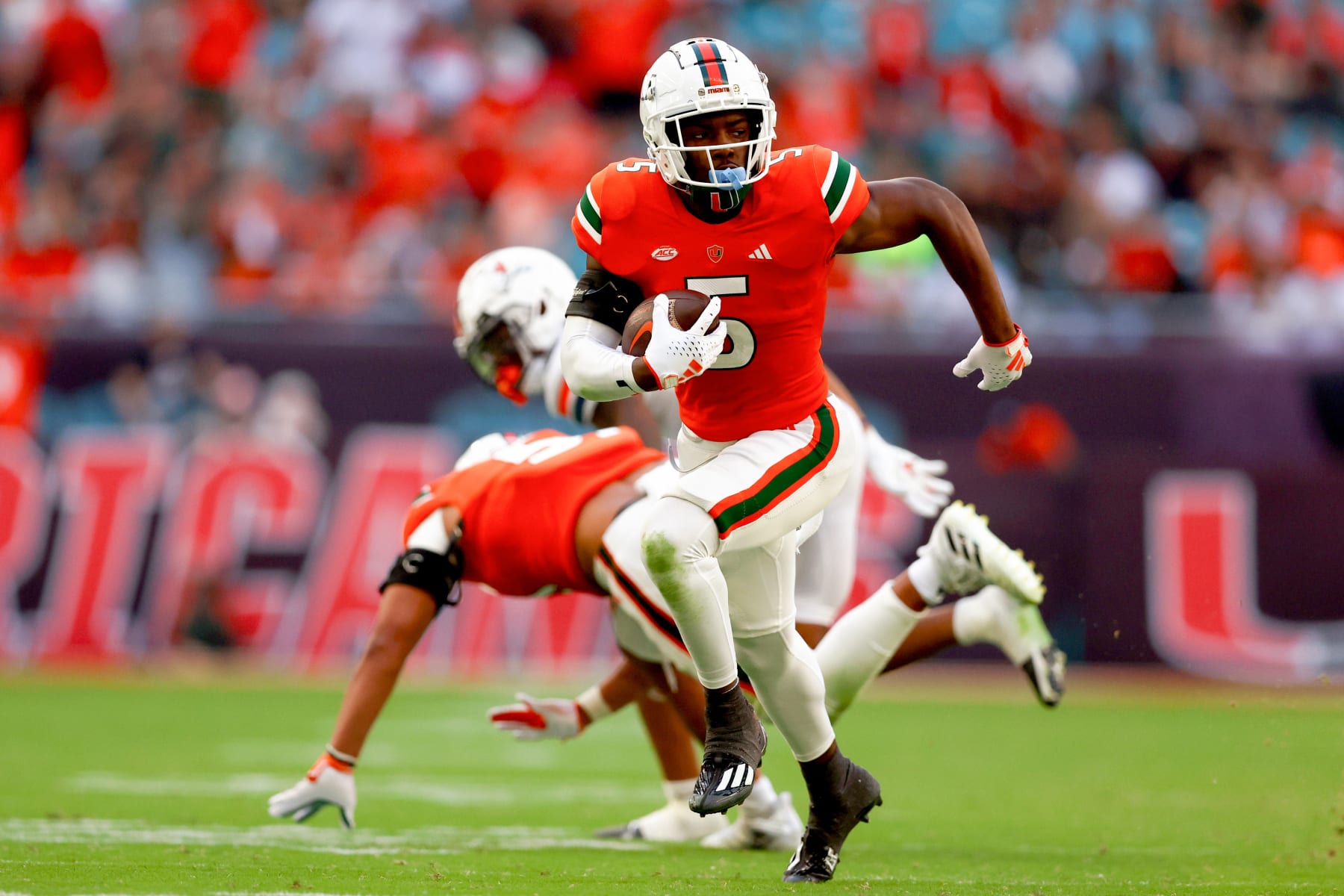 MIAMI GARDENS, FLORIDA - OCTOBER 28: Kamren Kinchens #5 of the Miami Hurricanes returns an interception for a touchdown during the third quarter of the game against the Virginia Cavaliers at Hard Rock Stadium on October 28, 2023 in Miami Gardens, Florida. (Photo by Megan Briggs/Getty Images)