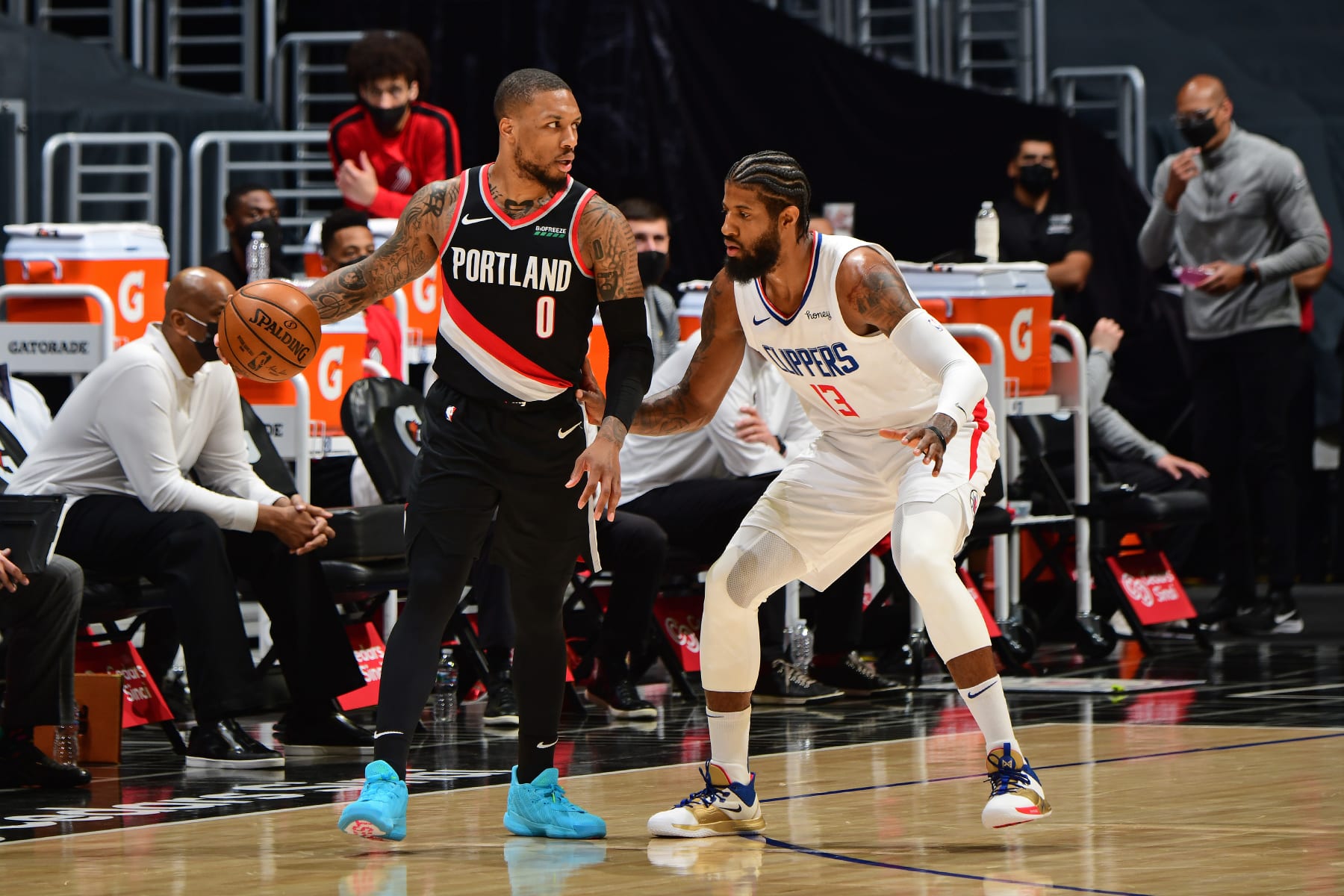 LOS ANGELES, CA - APRIL 6: Paul George #13 of the LA Clippers plays defense on Damian Lillard #0 of the Portland Trail Blazers during the game on April 6, 2021 at STAPLES Center in Los Angeles, California. NOTE TO USER: User expressly acknowledges and agrees that, by downloading and/or using this Photograph, user is consenting to the terms and conditions of the Getty Images License Agreement. Mandatory Copyright Notice: Copyright 2021 NBAE (Photo by Adam Pantozzi/NBAE via Getty Images)