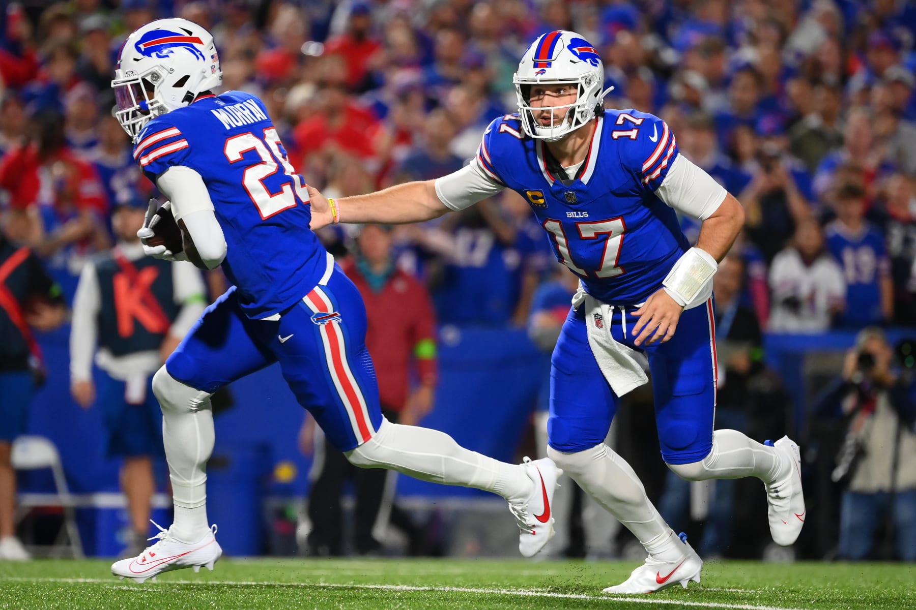 ORCHARD PARK, NEW YORK - OCTOBER 26: Josh Allen #17 of the Buffalo Bills hands the ball off to Latavius Murray #28 against the Tampa Bay Buccaneers during the first half at Highmark Stadium on October 26, 2023 in Orchard Park, New York. (Photo by Rich Barnes/Getty Images)
