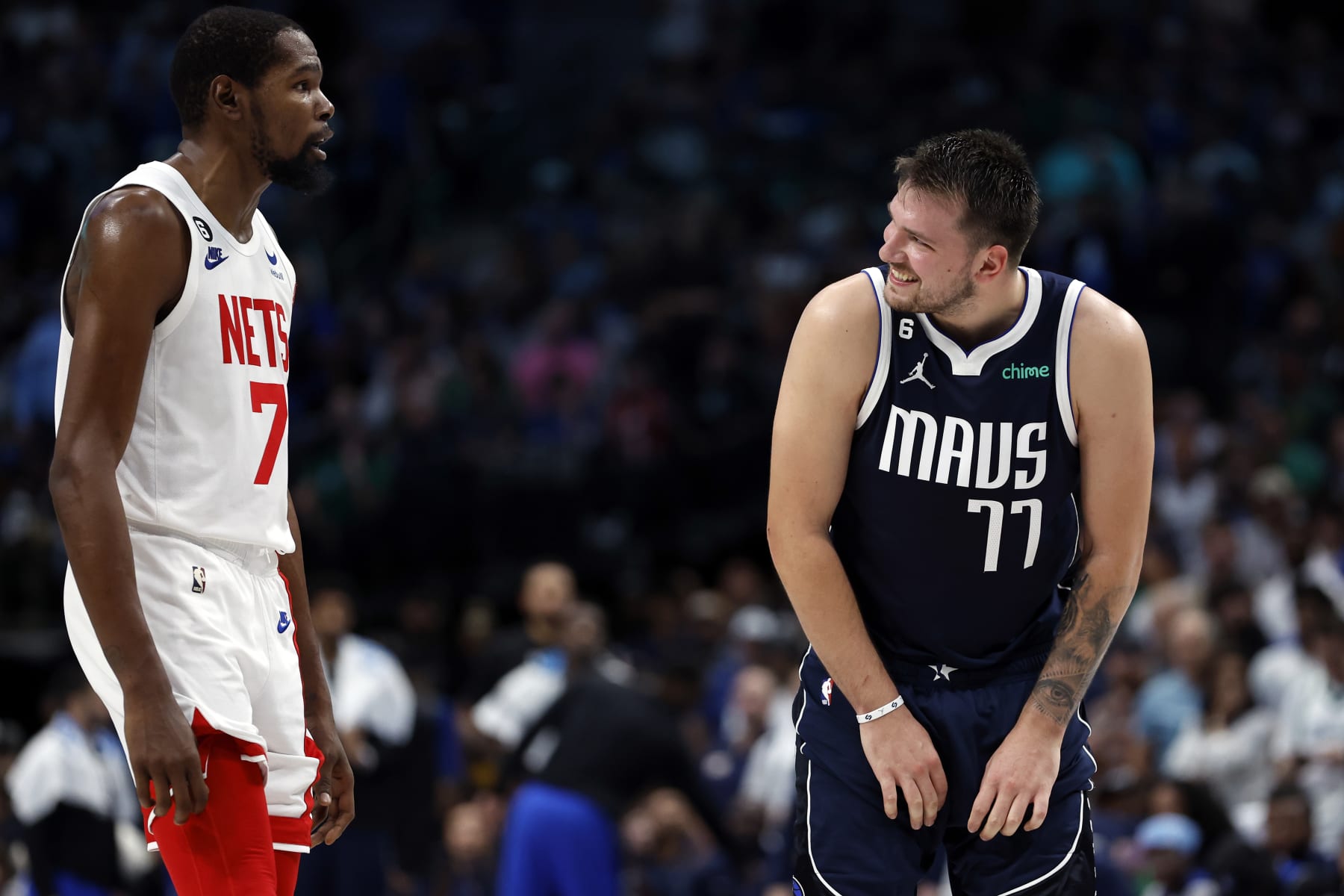 DALLAS, TEXAS - NOVEMBER 07: Luka Doncic #77 of the Dallas Mavericks smiles at Kevin Durant #7 of the Brooklyn Nets during the second half of the game at American Airlines Center on November 07, 2022 in Dallas, Texas.  NOTE TO USER: User expressly acknowledges and agrees that, by downloading and or using this photograph, User is consenting to the terms and conditions of the Getty Images License Agreement. (Photo by Tim Heitman/Getty Images)