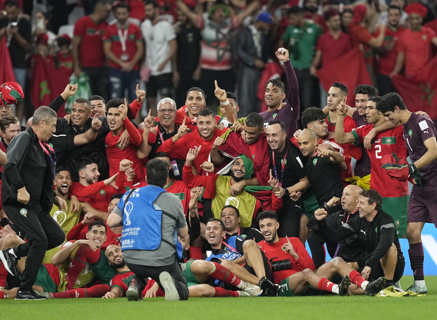 Morocco's team makes a group photo on the pitch after winning the World Cup round of 16 soccer match between Morocco and Spain, at the Education City Stadium in Al Rayyan, Qatar, Tuesday, Dec. 6, 2022. (AP Photo/Martin Meissner)