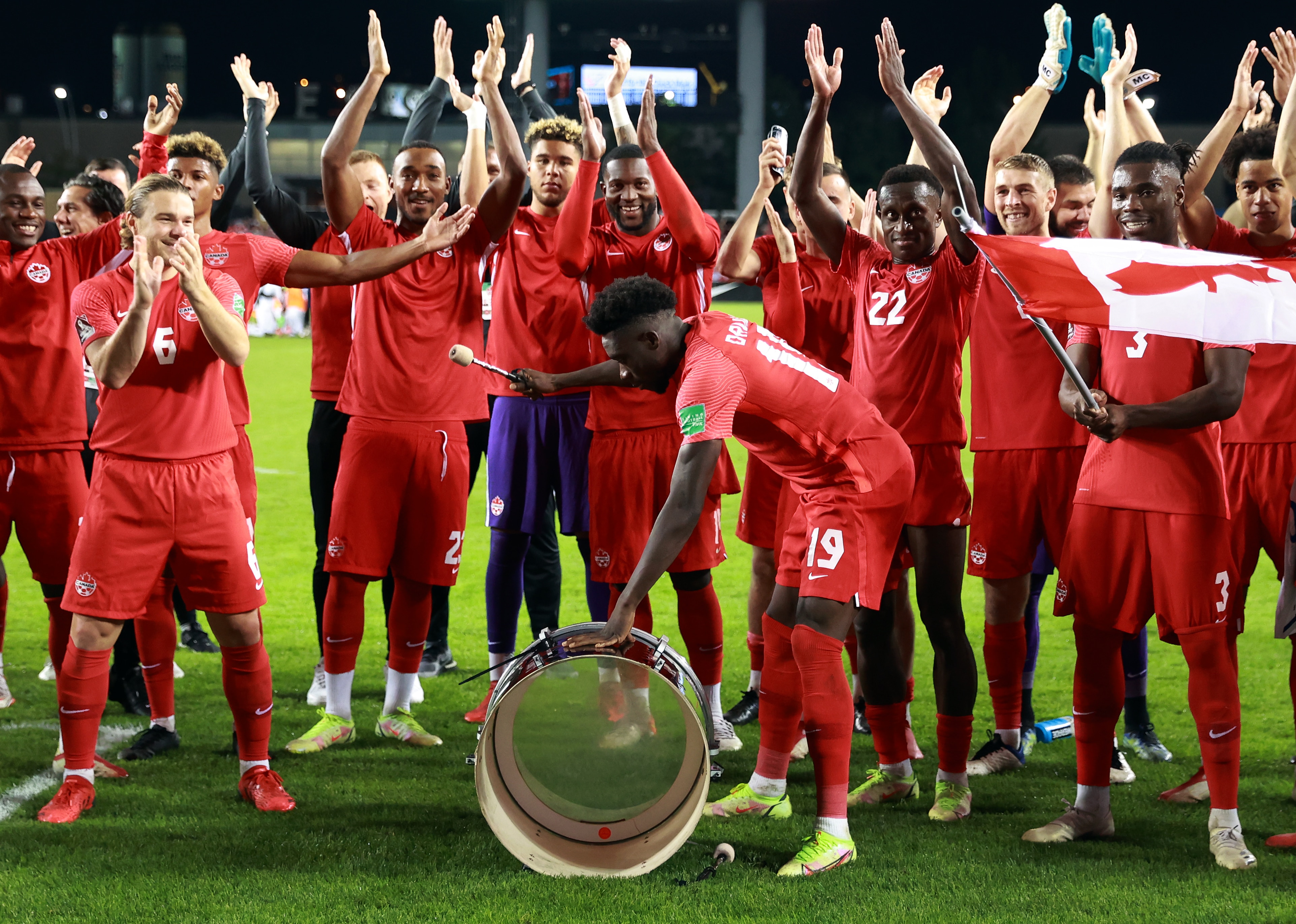 TORONTO, ON - OCTOBER 13:  Alphonso Davies #19 of Canada bangs a supporters drum following the final whistle of a 2022 World Cup Qualifying match against Panama at BMO Field on October 13, 2021 in Toronto, Ontario, Canada.  (Photo by Vaughn Ridley/Getty Images)