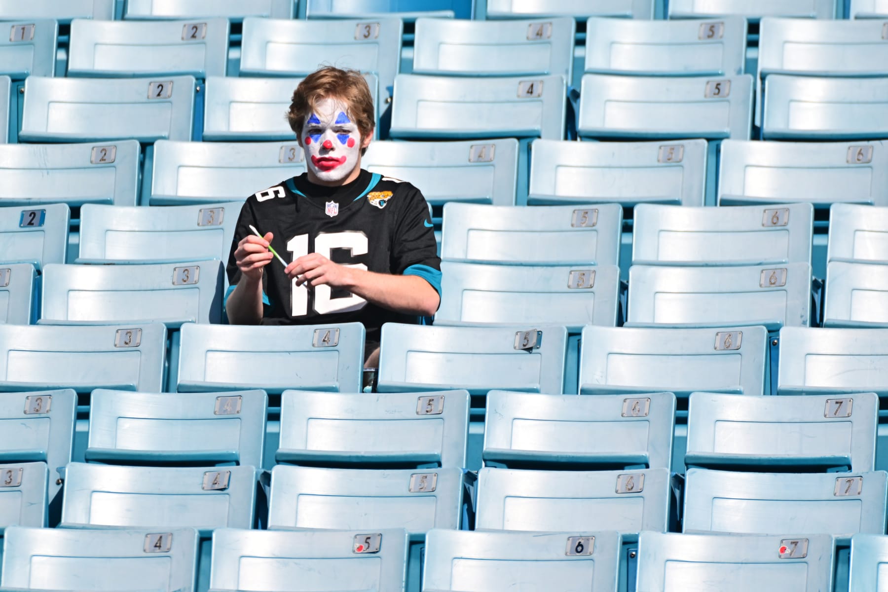 JACKSONVILLE, FLORIDA - JANUARY 09: A Jacksonville Jaguars fan painted as a clown in the stand before the game between the Indianapolis Colts and the jjj at TIAA Bank Field on January 09, 2022 in Jacksonville, Florida. (Photo by Julio Aguilar/Getty Images)