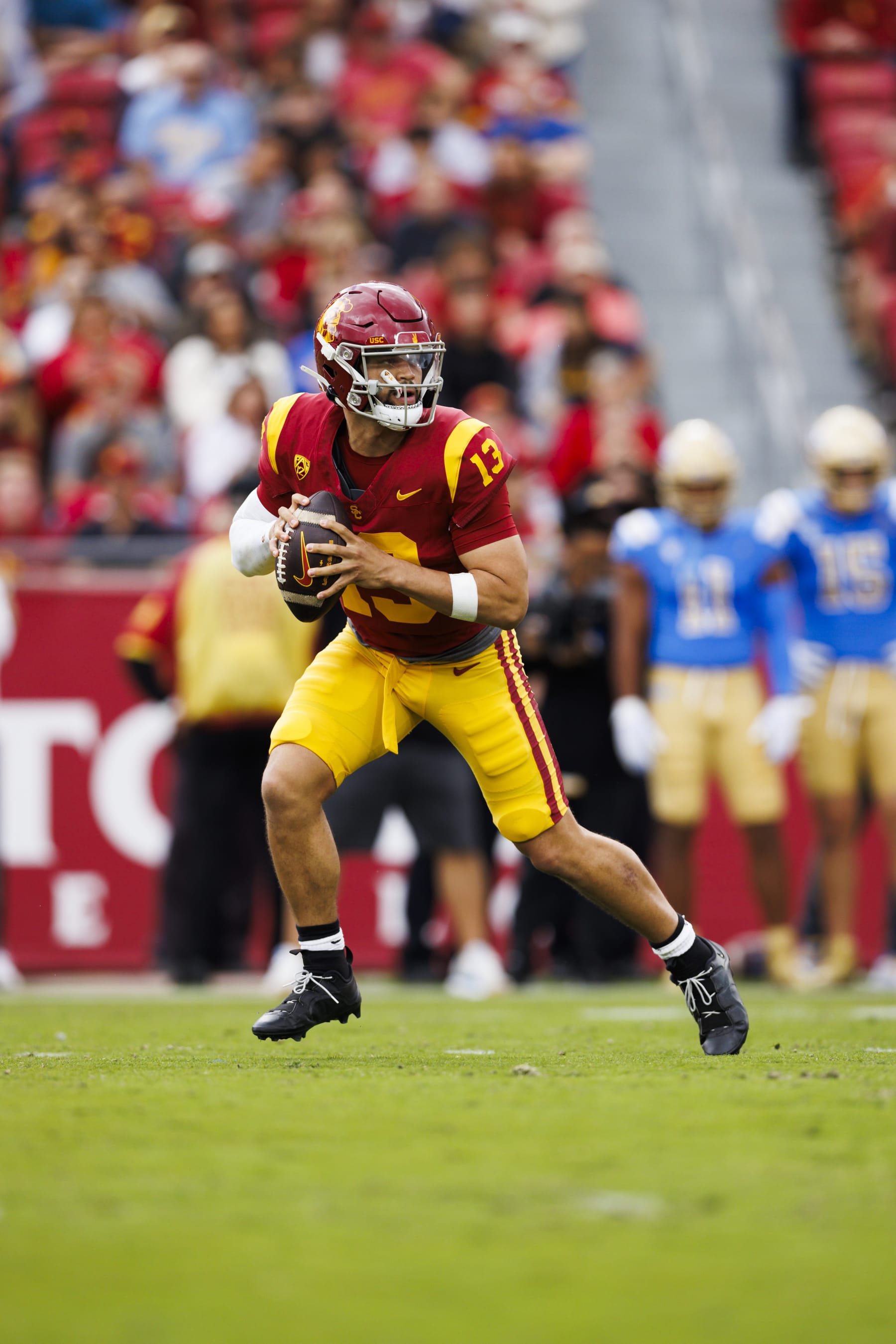 LOS ANGELES, CALIFORNIA - NOVEMBER 18: Caleb Williams #13 of the USC Trojans rolls out to pass during a game against the UCLA Bruins at United Airlines Field at the Los Angeles Memorial Coliseum on November 11, 2023 in Los Angeles, California. (Photo by Ric Tapia/Getty Images)