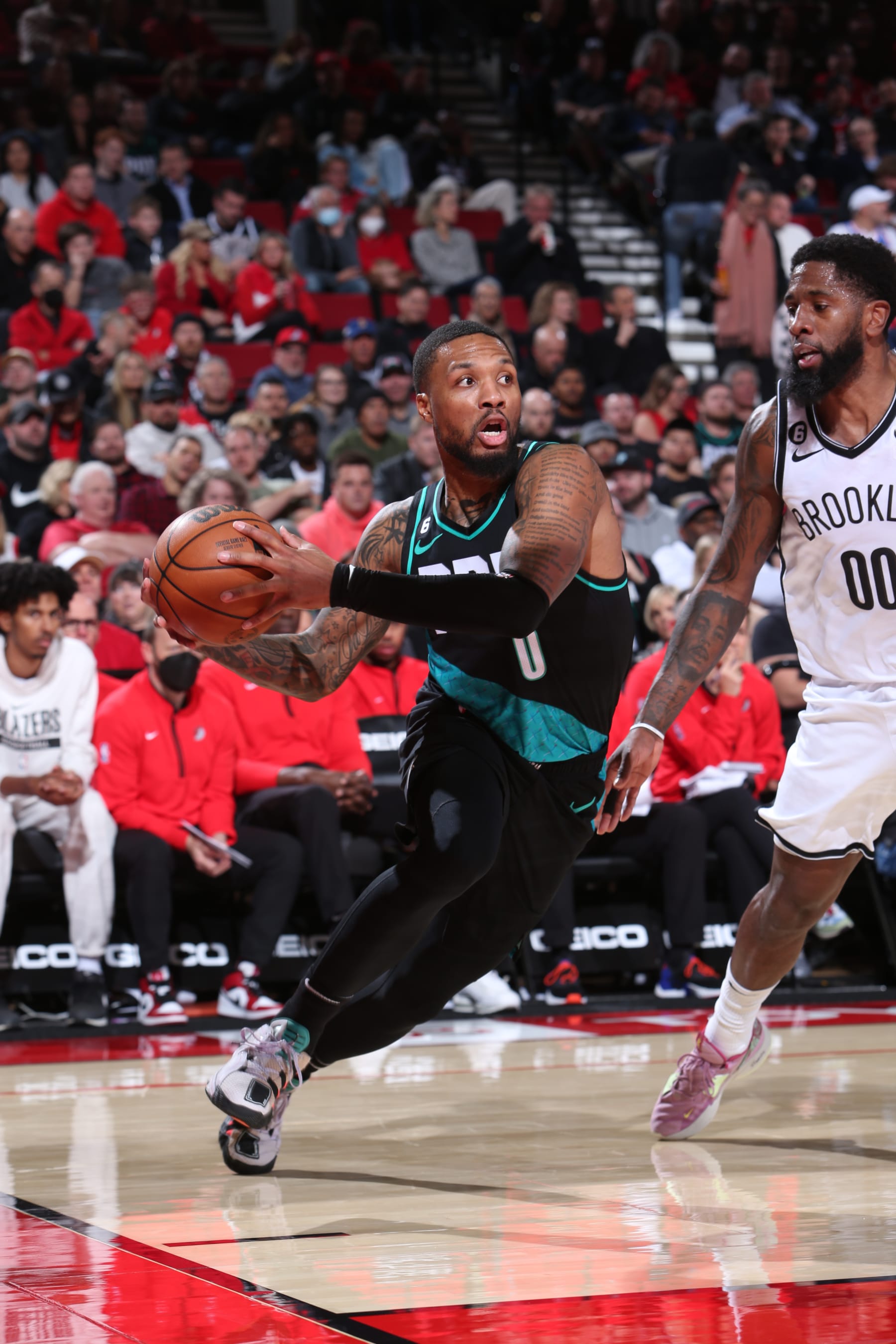 PORTLAND, OR - NOVEMBER 15: Damian Lillard #0 of the Portland Trail Blazers drives to the basket during the game against the Brooklyn Nets on November 15, 2022 at the Moda Center Arena in Portland, Oregon. NOTE TO USER: User expressly acknowledges and agrees that, by downloading and or using this photograph, user is consenting to the terms and conditions of the Getty Images License Agreement. Mandatory Copyright Notice: Copyright 2022 NBAE (Photo by Sam Forencich/NBAE via Getty Images)