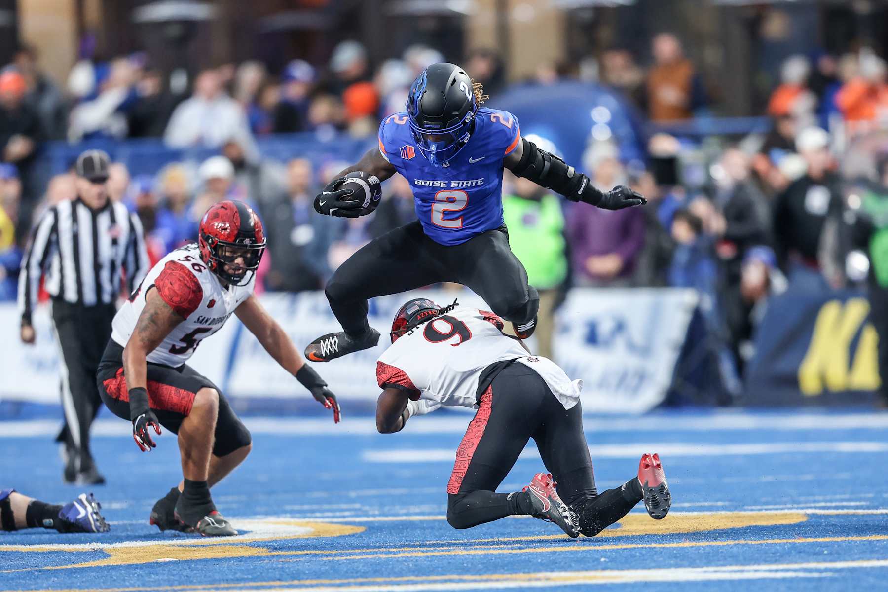 rBOISE, ID - NOVEMBER 01: Running back Ashton Jeanty #2 of the Boise State Broncos hurdles the tackle attempt of safety Dalesean Staley #9 of the San Diego State Aztecs during the first half at Albertsons Stadium on November 1, 2024 in Boise, Idaho. (Photo by Loren Orr/Getty Images)