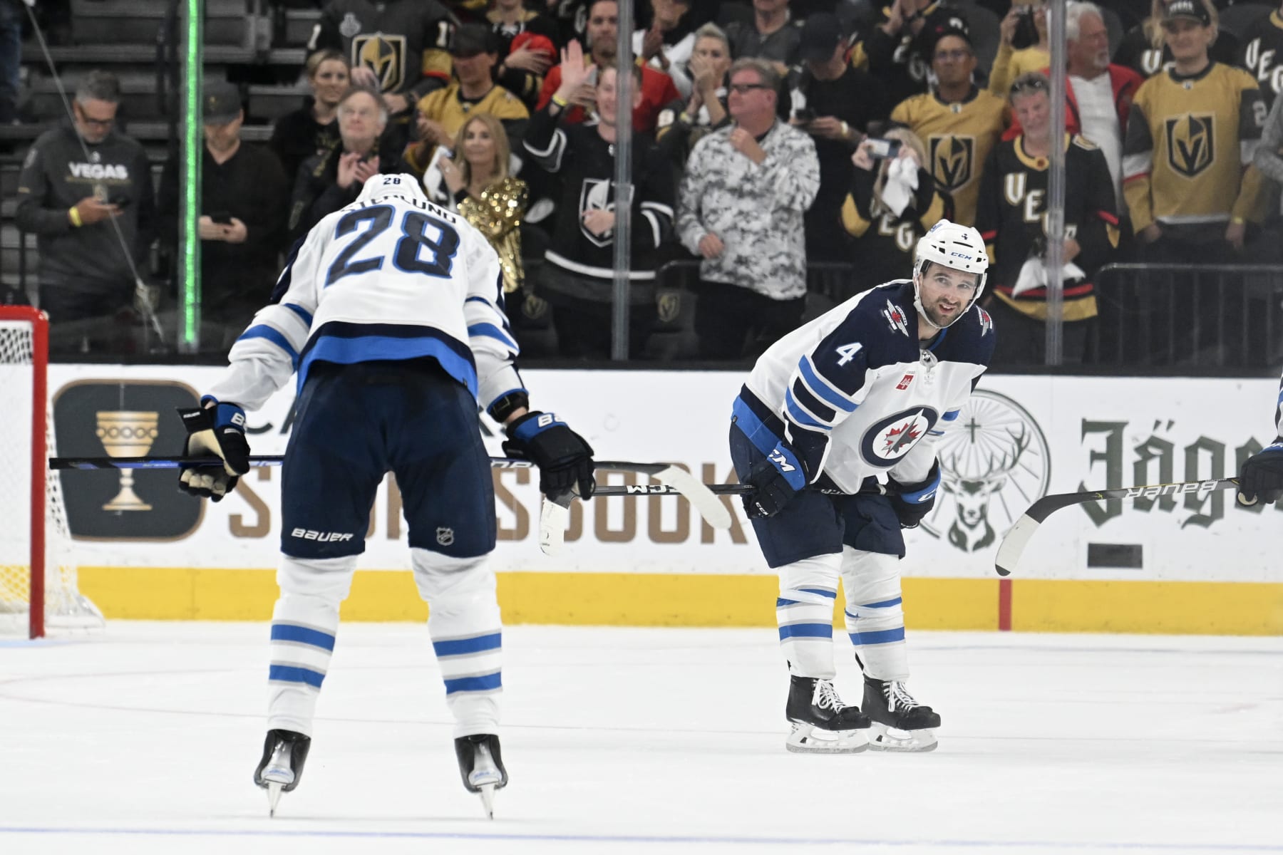 LAS VEGAS, NEVADA - APRIL 27: Kevin Stenlund #28 and Neal Pionk #4 of the Winnipeg Jets react after the team's 4-1 loss to the Vegas Golden Knights in Game Five of the First Round of the 2023 Stanley Cup Playoffs at T-Mobile Arena on April 27, 2023 in Las Vegas, Nevada. (Photo by Candice Ward/Getty Images)
