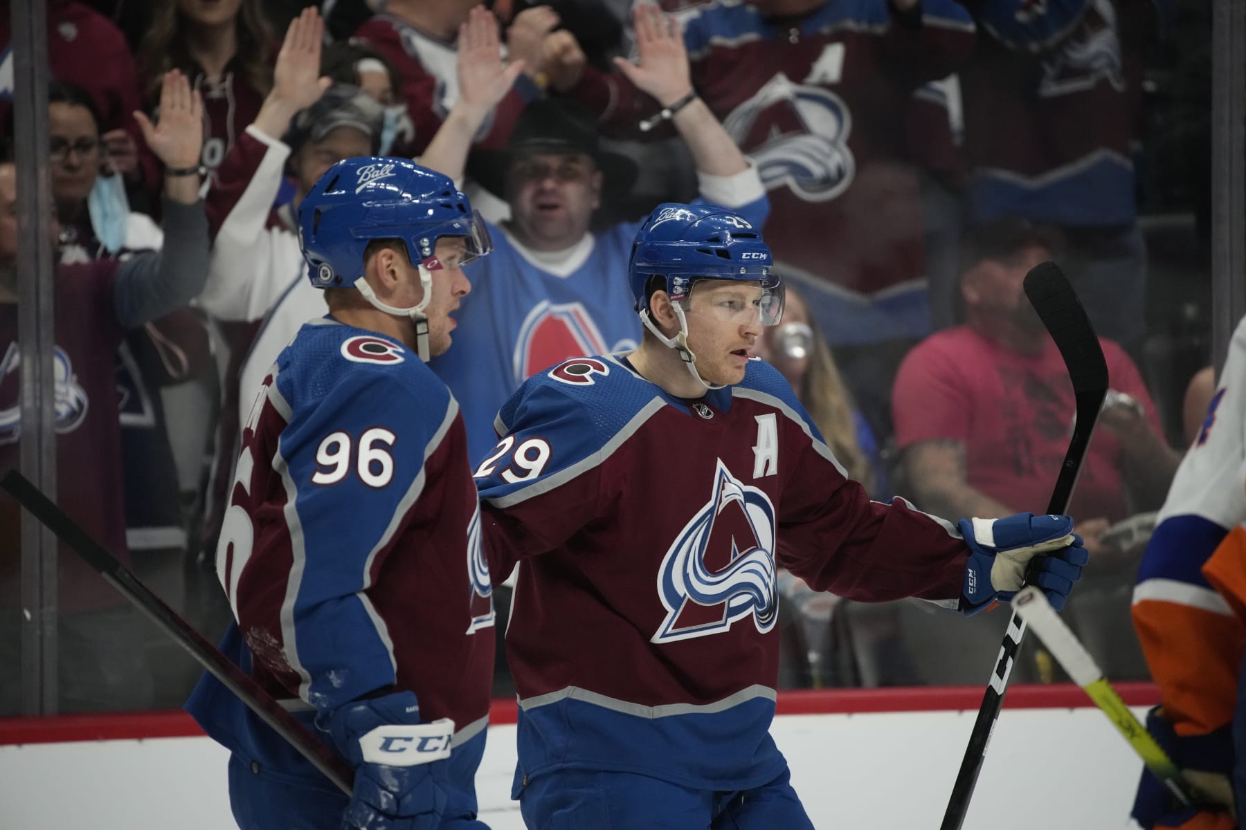 Colorado Avalanche right wing Mikko Rantanen (96) joins Colorado Avalanche center Nathan MacKinnon (29) after his goal in the first period of an NHL hockey game Tuesday, March 1, 2022, in Denver. (AP Photo/David Zalubowski)